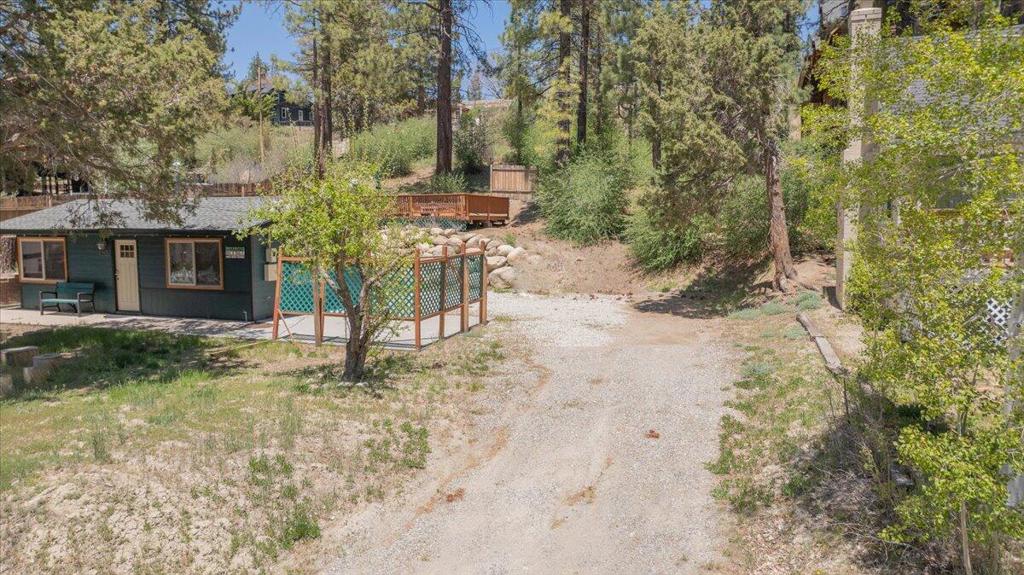 Charming Moonridge lot for your dream mountain cabin! Nestled in the trees, this inviting parcel offers the perfect canvas for a cozy retreat. The slight upslope allows for potential ski slope views from your new build site. Ideally located just down the road from Bear Mountain Resort, the Golf Course, the Big Bear Alpine Zoo, The Moonridge Room, Dank Donuts, Moonridge Coffee and more! it offers both adventure and convenience. Centrally situated near shopping and only minutes from the lake, this property blends accessibility with mountain charm. A beautiful apple tree graces the lot, along with a concrete pad framed by lattice privacy fencing--originally intended for a spa (though it may appear to belong to the neighboring property, it does not). Measuring 40 feet wide and 103 feet deep, it mirrors the dimensions of the adjacent cabin, offering a clear perspective on potential build options. Design the perfect mountain getaway--whether as a full-time residence, an investment property, or an ideal rental opportunity in this sought-after area!