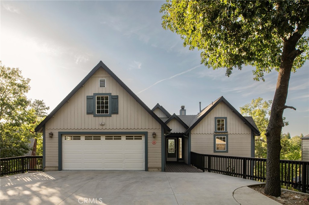 Surrounded by fruit trees that feel like your own private orchard, this 4 bedroom, 2.5 bath home blends comfort with convenience. Level entry from both the driveway and two car garage makes everyday living easy. Inside, a sun filled living room centers around the updated marble fireplace, while the kitchen, dining, and living spaces open to panoramic mountain views. Step out onto the expansive deck to take in the fresh mountain air and enjoy the view. The main level also features the primary ensuite, complete with its own deck access. Downstairs, you’ll find three additional bedrooms and a second living space that flows out to a private deck, perfect for morning coffee or winding down in the evening.
Just minutes from Tavern Bay Beach Club, Lake Arrowhead Village, McKay Park, and endless forest trails, this home truly checks every box. And yes, lake rights are included. Whether you’re looking for a full-time residence, vacation getaway, or investing, this is Lake Arrowhead living at its best.