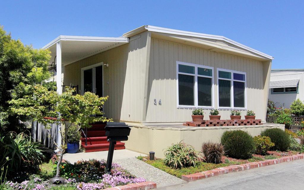 Quietly tucked away in the highly coveted Sorrento Oaks Co-Op Mobile Home Park, this charming garden home offers comfort, value & serenity in a special setting. Thoughtfully maintained & move-in ready, this is a true gem-where pride of ownership shines throughout. Step inside to find a neutral palette of light-filled rooms, efficient dual-pane windows & modern touches. Living & dining areas feature walls of windows, designed for both privacy & natural light, while framing tree-studded views. The cozy dining area w/built-in buffet cabinetry is ideal for display items while maximizing storage. The sunlit primary bdrm is a peaceful retreat, complete w/a Jack-and-Jill style walk-in closet offering excellent space & easy access. A generously sized 2nd bdrm, ideal as a guest room, home office or addt'l living space also with adjoining walk-in closet. The kitchen & bath have been tastefully updated w/modern touches, including tile countertops. Step outside & enjoy the private backyard setting, featuring drought-tolerant landscaping & a sun-drenched patio, perfect for gardening, reading, or soaking up the sun. A storage shed adds convenience for tools and extras. Sorrento Oaks is a well-managed, resident owned community for residents 55+ (second may be 52+), allowing 1 pet < 20 lbs.