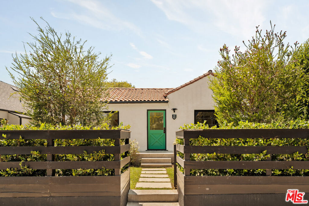 Welcome to Casa Bonita. This beautifully reimagined 1924 Spanish effortlessly fuses timeless charm, classic architecture, and elevated modern living. With a 3 bed, 3 bath main house + a converted garage with an additional full bath, this character-rich home delivers everything from soaring skylights to abundant natural light, vintage stained-glass windows and an airy open layout. At the heart of the home sits a spacious cook's kitchen, thoughtfully designed for both form and function. It features a large center island, Carrara marble countertops, handcrafted tile, and sleek custom cabinetry ideal for casual dining or upscale dinner parties. The primary suite offers a peaceful haven and is fit with a walk-in closet, a spa-like en-suite bath, and bi-folding doors showcasing calming views and access to the manicured backyard and pool. A private and lush backyard invites seamless indoor-outdoor living, equipped with a grassy sitting area, patio and pool. The bonus converted detached garage provides its own functional living space, a bedroom and full bathroom, adding incredible flexibility perfect as a guest suite, creative studio, or the ultimate poolside lounge. Tucked away on a quiet street just moments from the best of Melrose and Beverly, this one hits every note: timeless, stylish, and completely dialed in.