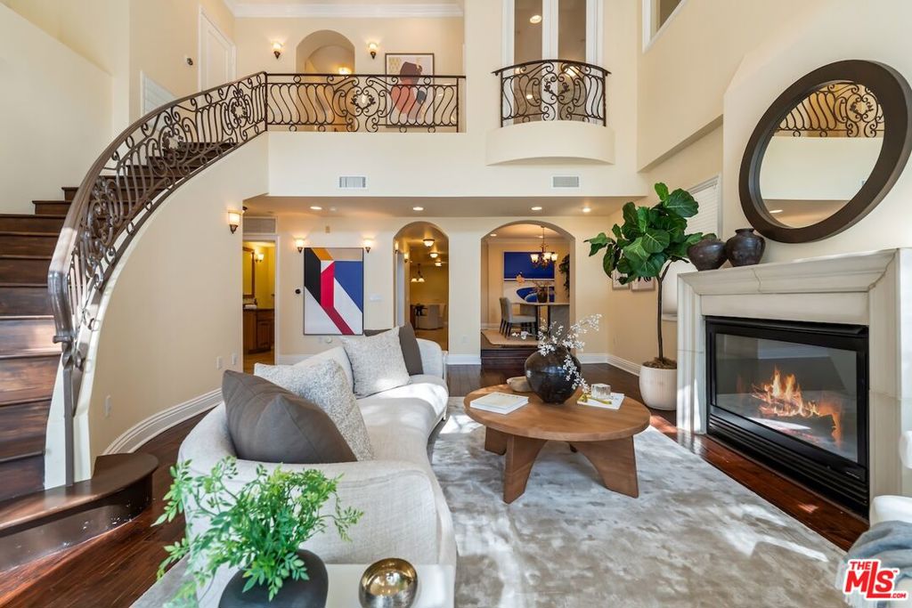 Nestled between Westwood and Century City, this Mediterranean-inspired townhome is one of only six in a private, secure enclave. Spanning 2,496 square feet across two levels, it offers the scale and comfort of a single-family residence with the ease of condominium living. A grand living room with soaring 18-foot ceilings and walls of glass sets the tone, filling the home with natural light and creating an airy, elegant ambiance. French doors open to a serene patio, blending indoor-outdoor living for intimate gatherings or relaxed evenings. The chef's kitchen, complete with Viking appliances, granite countertops, and custom cabinetry, is ideal for both culinary pursuits and casual entertaining. Upstairs, the expansive primary suite offers a tranquil retreat, featuring two walk-in closets and a luxurious en-suite bath with soaking tub. Two additional bedrooms provide versatility for family, guests, or a home office. Warm architectural details and timeless finishes create a sense of sophistication and ease throughout. Residents enjoy the peace of a secure, gated building entrance and parking, all within moments of award-winning Westwood Charter Elementary, the world-class shopping and dining of Century City, UCLA, and the best of West LA. Combining Mediterranean charm, generous scale, and a coveted location, this exceptional residence presents a rare opportunity to enjoy refined living in one of Los Angeles' most desirable neighborhoods.