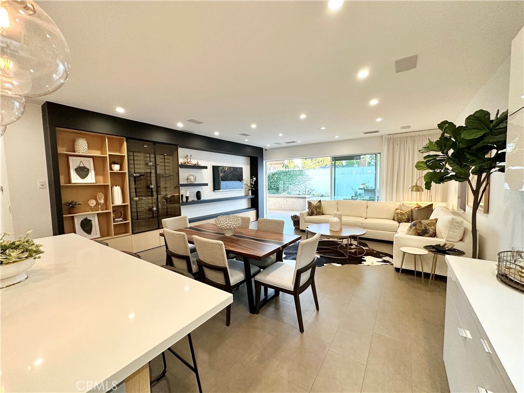 Stunning Smart Home with Designer Finishes and Luxury Features.
Welcome to this exceptional smart home in West Hills—perfect for homeowners and investors alike. Outfitted with fully paid solar panels, this property offers major savings on electricity bills while supporting a more sustainable lifestyle.
Situated in a prime location just minutes from Warner Center, the 101 Freeway, The Village at Topanga, Westfield Topanga, The Commons at Calabasas, and El Camino Shopping Center, this home truly has it all.
The main residence spans 2,074 sq. ft. and features 4 bedrooms and 3.5 bathrooms. The open-concept layout is filled with natural light and offers ample storage, recessed lighting, and tile flooring, with laminate flooring in the bedrooms. Custom doors, closets, and kitchen cabinetry enhance the home’s upscale appeal.
The gourmet kitchen is equipped with high-end appliances, a mini refrigerator, a spacious quartz island, and a large walk-in pantry—ideal for both everyday living and entertaining. The open family room boasts a custom-built entertainment center and sliding glass doors that lead to the backyard for seamless indoor-outdoor living.
The expansive primary suite includes a walk-in closet and a spa-like bathroom with a large shower and sliding glass doors opening to the backyard.
Designed for entertaining, the backyard features a generous patio with a gas fire pit, hanging gas heaters, a turf lawn, and fruit tree planters. The impressive outdoor kitchen includes an oversized bar with a pizza oven, built-in refrigerator, gas burner, and sink.
Additional highlights include security cameras, a fully enclosed gated front yard, and a washer and dryer included in the sale.
The property also offers a fully permitted 441 sq. ft. Accessory Dwelling Unit (ADU) with its own private entrance and address. The ADU includes vaulted ceilings, recessed lighting, and a full-sized kitchen with all appliances, and its own full bathroom—perfect for guests, extended family, or rental income.
This home is truly a must-see to fully appreciate its beauty, comfort, and functionality.