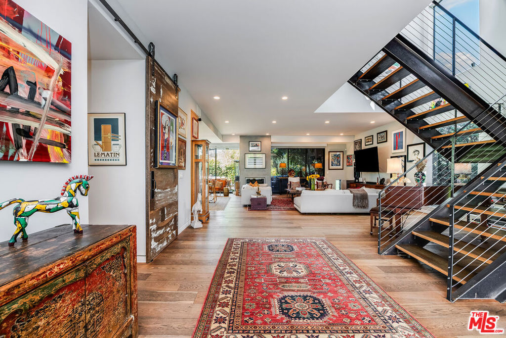 Beautiful architectural home on one of the most sought-after streets in Mar Vista. Perfect for any lifestyle - whether you're a family, couple, or single professional. The private backyard oasis is ideal for entertaining, complete with multiple gathering areas and a thriving vegetable garden. From the moment you step through the front gate, you'll feel the seamless indoor/outdoor flow: an open floor plan downstairs connects the gourmet kitchen, dining, and living spaces to fleetwood doors that open to the backyard. The kitchen is a chef's dream, designed for both indoor meals and alfresco dining. High ceilings, expansive wall space for art and striking architectural details, create an inspiring backdrop throughout the home. Upstairs, a cozy library leads into the private primary suite and two additional bedrooms. The rooftop deck offers yet another incredible entertaining space, with ocean views. Designed for both vibrant gatherings and warm, welcoming family living, this home truly has it all.