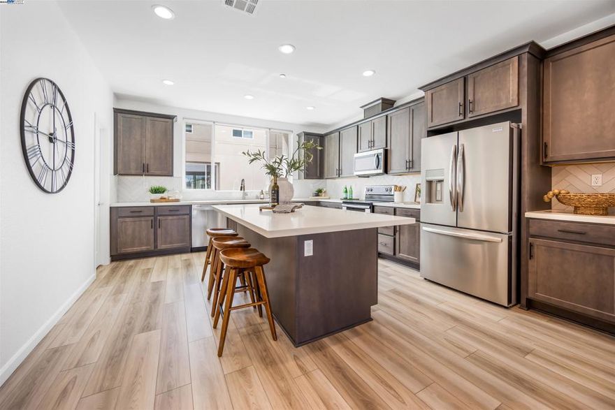 Experience the best of modern living in this spacious 2024-built Dublin home showcasing elegant design and thoughtful upgrades throughout. The versatile floor plan includes a first-floor bedroom with a full bath, ideal for guests or extended family, and an open-concept main level featuring upgraded quartz countertops, designer tile backsplash, and premium flooring. The third floor hosts three additional bedrooms, offering comfort and privacy for every member of the household.  Enjoy resort-style living with exclusive access to 15 pocket parks, the 31-acre Don Biddle Community Park, and a secured, state-of-the-art Recreation Center with lap and lounge pools, a fitness center, clubhouse, conference rooms, and a chef’s kitchen for gatherings.  Located in one of Dublin’s most desirable communities, this home offers immediate access to freeways, BART, premier dining, shopping, entertainment, and top-rated schools—all just moments away.  Discover a lifestyle where modern luxury meets everyday convenience.