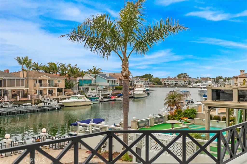 Discover the epitome of coastal elegance at 16201 Santa Barbara Lane, a stunning waterfront residence tucked away in the prestigious Huntington Harbor community. This impeccably maintained, turnkey residence offers a rare opportunity to experience the ultimate in coastal luxury, blending timeless elegance with modern comfort across 4,125 square feet of thoughtfully designed living space. Boasting 5 spacious bedrooms and 4 full bathrooms, this home is ideal for multigenerational living or accommodating guests with ease. The light-filled open floor plan features soaring ceilings, walls of glass, and seamless indoor-outdoor flow, creating an inviting atmosphere perfect for both relaxed family living and sophisticated entertaining. At the heart of the home, the gourmet kitchen is a chef’s dream—complete with top-of-the-line stainless steel appliances, custom cabinetry, a generous center island, and water views that make meal prep a joy. The living and dining areas offer uninterrupted views of the harbour, with multiple access points to the expansive patio, ideal for al fresco dining, lounging, or simply enjoying the ocean breeze. Upstairs, the primary suite is a true sanctuary, featuring a private waterfront balcony, cozy fireplace, spa-like ensuite bath with soaking tub, dual vanities, and an oversized walk-in closet. Additional bedrooms are equally well-appointed, offering flexibility for a home office, gym, or creative space. Step outside to your private paradise—complete with a 40-foot boat dock, providing easy access to open water. Whether you're cruising the coast, kayaking through the channels, or entertaining guests as the sun sets over the marina, this home offers a lifestyle that few can match. Located on a tranquil cul-de-sac in one of Huntington Harbor’s most coveted neighborhoods, this exceptional property combines the peace of waterfront living with convenient proximity to shops, dining, award-winning schools, and the beach.