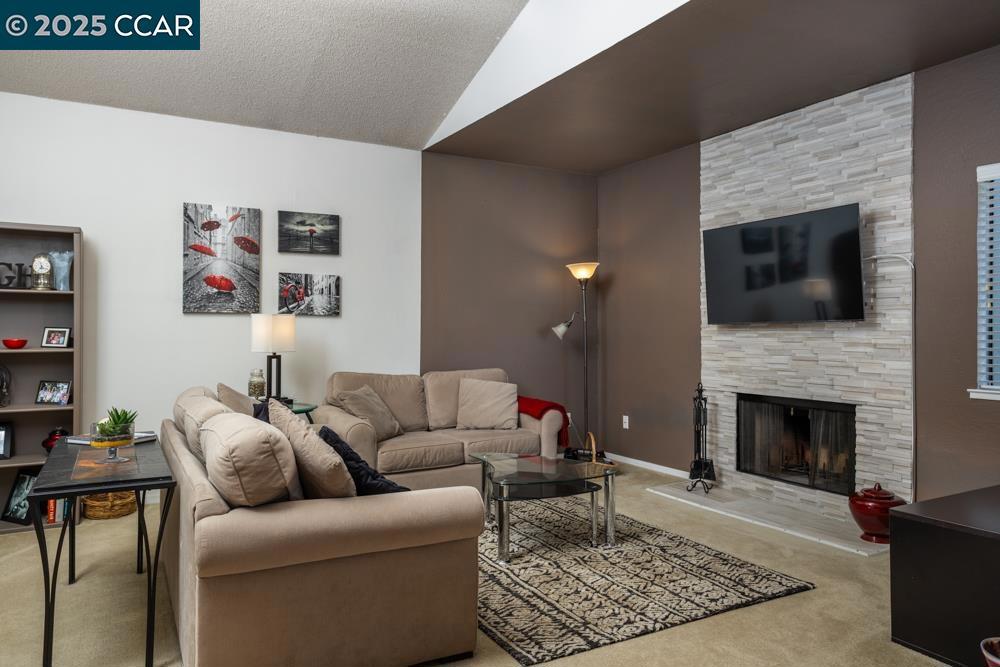 Welcome to this light and bright upper-end unit condo in the heart of Martinez! Offering 2 spacious bedrooms and 2 well-appointed bathrooms, this home is the perfect blend of comfort and style. As you enter, you’re greeted by soaring vaulted ceilings that create a sense of openness and light throughout the living space. The cozy living room features a wood-burning fireplace—ideal for relaxing evenings or entertaining guests. The kitchen is both functional and stylish, featuring a breakfast bar that opens up to the dining and living areas, making it perfect for casual dining or socializing. Bonus: Included in the sale are the washer, dryer, refrigerator, microwave, and even the stylish stools at the breakfast bar! The generous primary bedroom comes with ample closet space and its own en-suite bathroom. The second bedroom is equally spacious and can easily serve as a guest room or home office. Plus, enjoy the convenience of inside laundry and central heat and air for year-round comfort. Step outside to your private balcony, where you can unwind and take in the peaceful surroundings. As part of a well-managed community, you'll enjoy a wealth of amenities, including internet, cable, water, and garbage.A standout feature of this condo is the detached garage and an assigned parking.