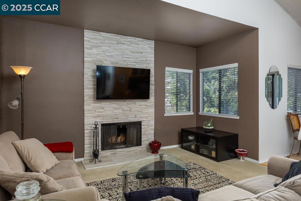 Welcome to this light and bright upper-end unit condo in the heart of Martinez! Offering 2 spacious bedrooms and 2 well-appointed bathrooms, this home is the perfect blend of comfort and style. As you enter, you’re greeted by soaring vaulted ceilings that create a sense of openness and light throughout the living space. The cozy living room features a wood-burning fireplace—ideal for relaxing evenings or entertaining guests. The kitchen is both functional and stylish, featuring a breakfast bar that opens up to the dining and living areas, making it perfect for casual dining or socializing. Bonus: Included in the sale are the washer, dryer, refrigerator, microwave, and even the stylish stools at the breakfast bar! The generous primary bedroom comes with ample closet space and its own en-suite bathroom. The second bedroom is equally spacious and can easily serve as a guest room or home office. Plus, enjoy the convenience of inside laundry and central heat and air for year-round comfort. Step outside to your private balcony, where you can unwind and take in the peaceful surroundings. As part of a well-managed community, you'll enjoy a wealth of amenities, including internet, cable, water, and garbage.A standout feature of this condo is the detached garage and an assigned parking.