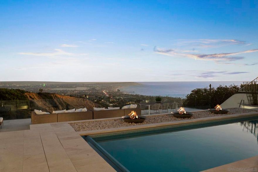 Recently remodeled to perfection, this uber luxurious custom contemporary offers a striking panorama of ocean, bay and City views. Setting the bar high with top-of-the-line amenities, appliances and designer elements, the home’s interior spaces offer high ceilings to maximize scale without sacrificing intimacy. Living spaces are oriented to the captivating views while a nuanced interplay of sunlight enlightens the home’s modern aesthetic.  Privacy abounds throughout the property, providing an exceptional foundation for intimate or large-scale gatherings. The home’s expansive exteriors offer a plethora of opportunities in which to play, relax, and congregate. Three firepits surround the sparkling pool and spa denoting the entertaining terrace as an ideal place to gather for meals, amusement and conversation. A flexible guest house acts as a residence for extended stays, workspace, or private studio.  Anchored by views that cannot be replicated, this special home embodies the highly sought-after La Jolla lifestyle.