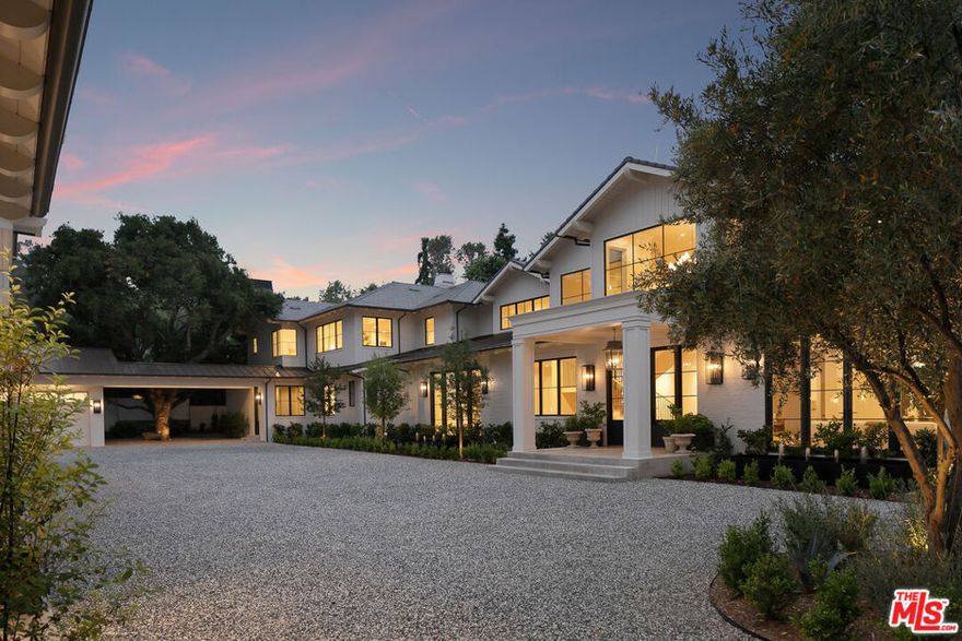 $2.9 Million Dollar Price Reduction. Located in the prestigious Rustic Canyon on a private flat one-acre behind gates, The Estate showcases the highest level of immaculate detail, timeless craftsmanship and design. Immerse yourself in a world of tranquility with the feel of a meadow-like retreat surrounded by towering Sycamore trees. This newly constructed Hamptons-esque Traditional features seven bedrooms and thirteen bathrooms, six car garage and a detached guest house with living room, dining room, kitchen and separate bedroom creating a perfect space for staff or family visitors. Driving through the beautifully arched brick porte-cochere and sweeping motor court, you're met with a grand foyer, spacious formal living room with wood burning fireplace and a sun-filled dining room with fireplace and chic bar. The formal study with sliding doors leads to the expansive covered patio deck, perfect for al-fresco dining and entertaining. The gourmet kitchen features a double island, state-of-the-art appliances, exquisite European marble finishes, breakfast area and service kitchen nearby. The kitchen opens to a large family room with fireplace and sliding doors, continuing the indoor-outdoor lifestyle. A further expansive family-parlor room boasts high-vaulted ceilings with wood beams, custom wall-to-wall built-ins, fireplace and full-service bar. Additionally, this estate features a private screening room, temperature-controlled wine cellar, a gym and health spa. The picturesque staircase welcomes you upstairs to a bright and open sitting room, along with four guest suites all with en-suite baths. The primary suite with fireplace offers a sitting room with a private balcony, dual bathrooms and closets. The sprawling grounds and beautiful landscaping features a pool, jacuzzi and outdoor kitchen with seamless vista views providing the utmost privacy. This Estate is the epitome of perpetual elegance and charm, truly a rare offering.