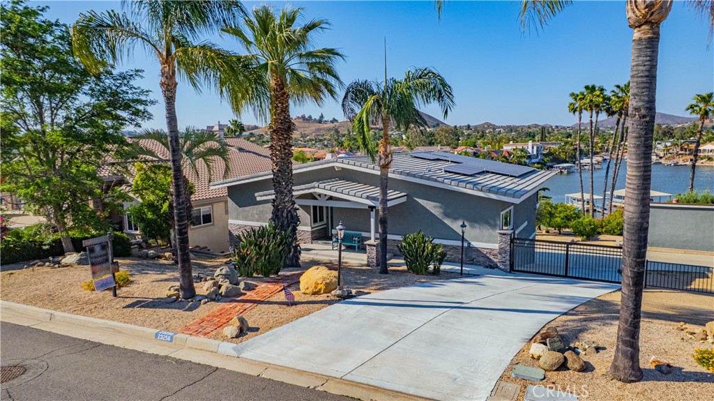 Welcome to one of Canyon Lake’s most treasured properties – the second home ever built and the first lot purchased in this private lakeside community. Steeped in history and lovingly maintained by the same family for generations, this extraordinary waterfront retreat is now available for the first time.
Situated on over half an acre along the serene East Bay, this beautiful exterior. remodeled 3 bed, 3 bath home offers 2,312 sq ft of comfortable living space with unmatched lake views and a rare sandy beach shoreline—a true gem for water lovers. Enjoy effortless lakefront living with a double dock, featuring dual HydroHoist lifts and a covered roof, perfect for boating and lakeside entertaining. A detached workshop provides ample space for hobbies, storage, or future customization. Tucked away on one of the most desirable and quiet streets in Canyon Lake, this home features a gated private driveway, mature landscaping, and recent renovations that blend modern comfort with timeless charm. Whether you’re looking for a peaceful weekend getaway or a legacy property to pass down through generations, 23256 Gray Fox is a once-in-a-lifetime opportunity to own a piece of Canyon Lake history. Note: This property has New roof, AC and leased transferable solar with Tesla battery back up to offset your electric bill and keep your lights on when power is out!!!