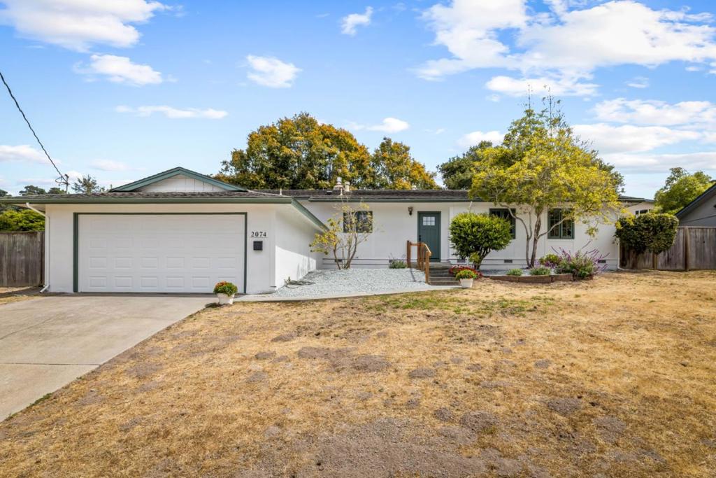 Welcome to this sunny four bedroom home in Fisherman's Flats with a California-style open floor plan featuring gleaming hardwood floors.This home has been extensively remodeled and recently painted inside and out. Enjoy a peek of the ocean from the kitchen window, while preparing meals for family or guests. Also from the main living area, enjoy separate views of both side and rear patios. The spacious living space has a free standing gas fireplace, with remote controls. The bedroom wing, of this 1,524 sq ft residence, offers a primary bedroom with an adjacent bathroom featuring a walk-in shower. The hall bathroom includes a shower over tub. The kitchen has a high-end gas oven range, and the washer and dryer are conveniently located in an adjacent cabinet. The fourth bedroom along with the primary bedroom would make an ideal potential Auxiliary Dwelling Unit, as it has its own entrance. This home has a large, totally fenced back yard with patios, making it ideal for pets and for gatherings. The attached two-car garage adds convenience and storage options. In the side yard, an approximately 7 x 8 foot Playhouse is suitable for children's play or storage. Note: Property condition and all dimensions and descriptions to be verified by Buyer.