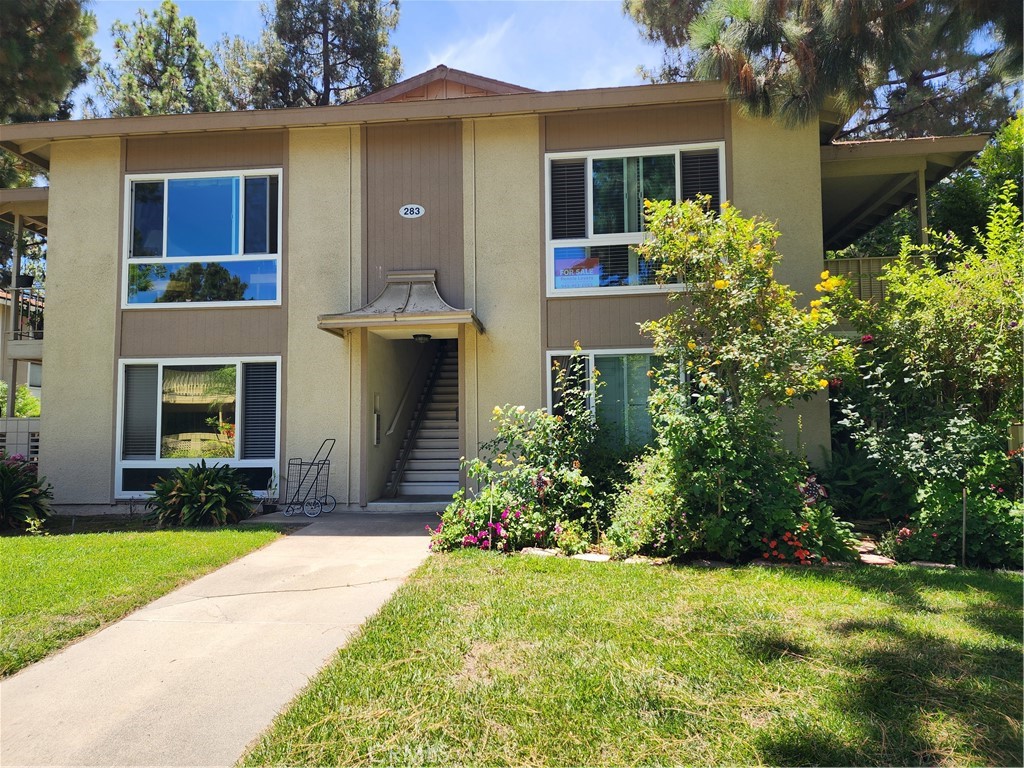 This "Cadiz Model" 1 bedroom, 1 bath residence is a true treehouse. The home has a panoramic view of the neighborhood, parklike area, and many trees.
You will like the quiet area and the private balcony attached to the living room. There is an AC heat pump and dual pane windows with shutters in the spacious living room. The kitchen is complete with refrigerator, dishwasher, glass cooktop, microwave and oven. The dining room is attached to the kitchen and has room for additional cabinets. The bedroom has dual pane windows, vertical blinds and curtains plus a large closet with sliding doors. The bathroom has a newer sink top and faucets plus a tub/shower plus a solar tube. The bathroom host many cabinets great for linen storage. The carport parking is in Garage #266, Space 9 located in front of building. There are storage cabinets in the carport.The community laundry is just a few steps on the left side of the parking lot. Enjoy the amenities in this senior Laguna Woods Village: 7 Clubhouses, Gate guarded security, championship 27 and 9 hole gold courses, five heated pools, tennis courts, pickleball courts, equestrian center, RV storage, lawn bowling, gyms, gardening center, art studio, wood ship, computer workrooms, clases and over 200 clubs and organizations. Only minutes from Laguna Beach, shopping malls, freeways and toll road.