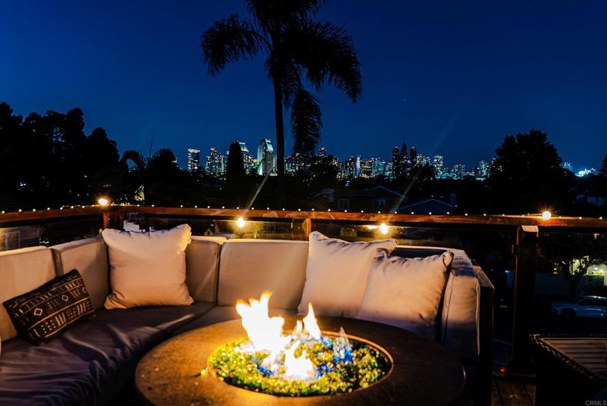 This is THE ONE. Every detail of this elegant Coronado home has been thoughtfully designed to impress. Custom light fixtures grace the downstairs living areas, with perfectly matched wall sconces flanking the archway into the dining room. The flow is seamless from indoors to the expansive backyard patio - fully fenced and beautifully lit at night - creating an enchanting setting for unforgettable gatherings. Offering 1,453 sq.ft. of upgraded space, this detached two-story home features 3 bedrooms, 2 bathrooms, and a chef’s dream kitchen with granite countertops, an espresso bar area, custom cabinetry with floating shelves and recessed lighting. Details like crown molding, plantation shutters, and original hardwood flooring elevate every corner. The primary suite includes a private balcony with views to downtown San Diego - perfect for your morning coffee. And when it comes to entertaining, nothing compares to the oversized rooftop deck with panoramic views of the San Diego Harbor, Coronado Bridge, sparkling downtown skyline, and unforgettable sunsets. Picture yourself hosting friends for champagne toasts at sunset or cuddling under a blanket with someone special as the city lights twinkle all around you. It’s not just a deck - it’s a lifestyle, and it’s pure romance. New roof (Jan. 2025) and beautiful hardwood floors under carpet in bedrooms. Centrally located - just a short stroll to the Ferry Landing, Orange Avenue’s shops and dining, the golf course, and waterfront parks, plus quick access to the bridge when you need it. This is hands-down the best value on the Island. Don’t miss your chance to own it!