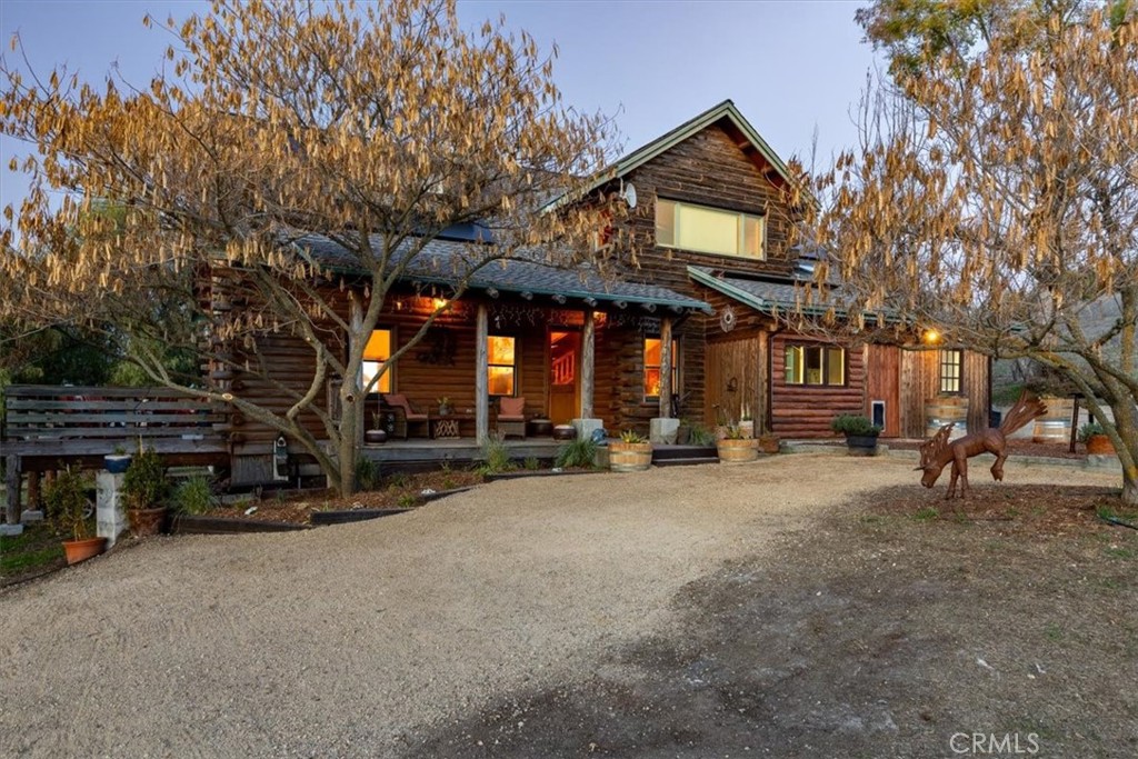 This nearly 16-acre piece of paradise offers endless possibilities for development, thanks to its desirable terrain featuring plenty of flat, usable areas. It's perfect for you and your extended family to create your own family compound. Conveniently located just off the beautiful wine trail on El Pomar, the property is surrounded by stunning vineyards and is only minutes away from both Templeton and Paso Robles. The property includes a stunning 2,360 sq ft log home, completed in 2023, featuring three bedrooms, three bathrooms, and a beautiful office. The exterior was just pressure washed, re-caulked, stained, sealed and painted the exterior siding, porches, balcony, and patio. A second original 1,300 sq ft home built in 1980, currently used as a duplex. Additional amenities include two RVs with full hookups, a dump station, a modified 6-stall Port-a-Stall barn with runs, a 2-stall barn with turnouts, a 1,200 sq ft shop/hay barn with a concrete floor, a 150' x 100' arena, solar systems and 7 pastures—6 of which have shelters. There's also a storage container for added convenience.