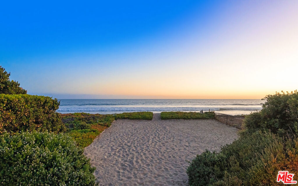 This stunning property has pleasant surprises throughout. A pedestrian gate leads immediately to a 2-car detached garage. Up a set of stairs is the first surprise--a living unit with a gym! The gym is equipped with a powder room, mat floors, and sliding glass doors to expand the workout area onto the deck overlooking the ocean. This is ideal for a personal trainer or professional athlete wanting a designated space. Descending to the lower balcony, you have the main unit. A private guest suite features a wood-beamed ceiling, French doors, and a balcony overlooking the ocean. The guest suite is complete with an ensuite bath, including a shower, sink, built-in cabinetry, a mini fridge, and generous closet space. Outside the guest suite, the courtyard displays a beautiful fountain before descending the final level to the main home. Upon entering the main foyer, you are greeted by ocean views before a tube elevator escorts you to the living area. The focal point of the living room is a large fireplace surrounded by plenty of built-in shelving. Plus, it has a 2-story beachfront deck with outdoor seating, a dining area with a fire pit, and a private beach. Ideal for indoor-outdoor entertaining! The kitchen features black stone countertops, accentuating the wood-beam ceiling and tile floors with modern elegance. Equipped with commercial-grade appliances, floating shelves, island seating, and an adjoining dining area, it's perfect for indulging in culinary delights. A stunning master suite showcases high ceilings, a skylight, fireplace, floating shelves, and a large walk-in closet with a laundry facility inside, plus glass French doors leading onto a private deck with a living area, wet bar, outdoor fireplace, and sweeping views of the coastline. If you're looking for a unique, luxurious property that allows you to live, work, and play, this is it! Available for lease $85,000 per month.