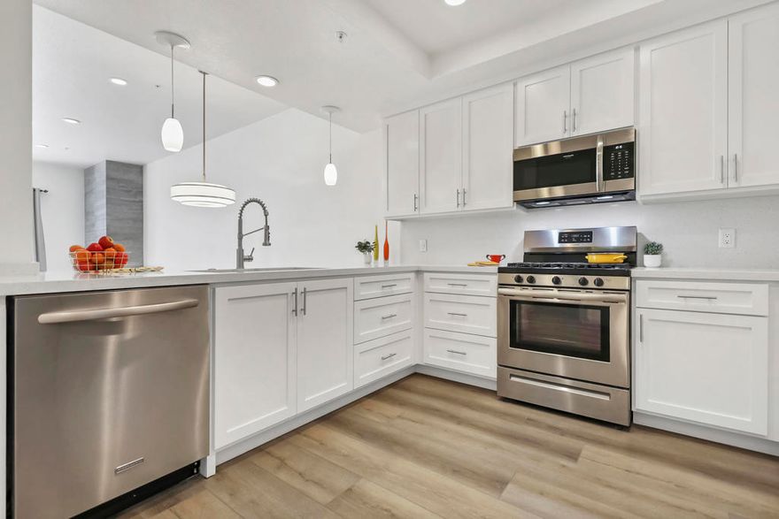 PRICED for Prompt Sale! Stylish remodel recently completed on this larger ground-floor, single-level condo in desirable SOUTH PALM SPRINGS -- and it's on FEE LAND! The open-concept design showcases oversized windows, high ceilings, and a dramatic floor-to-ceiling tiled fireplace in the great room, creating a bright, welcoming atmosphere. The fully remodeled kitchen is both functional and striking, with quartz countertops, custom cabinetry, counter-height breakfast bar, single stainless sink, and brand-new 2025 dishwasher and gas range. Both bathrooms are thoughtfully updated with quartz counters, new cabinets, a tiled tub/shower combo, and a step-in tiled shower in the primary suite. Extra linen cabinetry adds storage convenience.  The primary suite offers double closets (including one walk-in) plus direct patio access -- an inviting space to enjoy morning coffee or evening relaxation. The versatile den can easily serve as a third bedroom, office, or hobby space depending on your needs. Additional features include luxury vinyl plank flooring throughout, ceiling fans in every bedroom, full-size laundry, and a new HVAC system (2022), helping keep utility costs comfortably low. Mountain views can be enjoyed from both the primary and guest rooms, enhancing the appeal of daily living. Located adjacent to one of the pools, this home makes enjoying the community's amenities effortless. Summerset Springs is a beautifully maintained gated community offering two pools, two spas, BBQ areas, lush lawns, and mature landscaping. Residents also enjoy covered assigned parking plus plenty of guest spaces, all with LOW HOA dues. This prime South Palm Springs location is directly across from Rimrock Plaza (Vons Center), and just minutes from golf courses, shopping, dining, entertainment, and outdoor activities. Palm Springs International Airport is approximately 3 miles away, making travel exceptionally convenient. HOA guidelines permit rentals of 30 days or longer, supporting both full-time residents and seasonal living.  Truly a stylish, move-in-ready property that blends modern upgrades with an ideal Palm Springs lifestyle. See attached list of recent upgrades and special features.