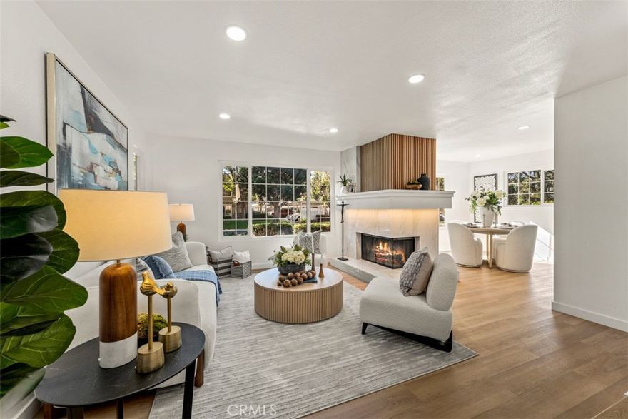 Located in the desirable Woodbridge Village, this beautifully renovated 3-bedroom, 2-bath end-unit offers effortless single-level living on the ground floor. Enter through a private enclosed patio and step into a bright, open floor plan thoughtfully updated throughout. The brand-new kitchen showcases custom oak cabinetry, Taj Mahal quartz countertops, recessed lighting, and new luxury vinyl plank flooring that flows seamlessly through the home. Both bathrooms have been completely remodeled with floor-to-ceiling tile, matching oak vanities, and Taj Mahal quartz counters, creating a cohesive and elevated design. Additional upgrades include new closets, doors, hardware, fresh interior paint, and a brand-new air conditioning unit, ensuring both style and comfort. Each bedroom and the living area are filled with natural light, enhancing the home’s airy feel. The unit includes an assigned covered carport (#165), with ample guest parking available nearby. Ideally situated close to Woodbridge High School, Woodbridge Lakes, Crossroads and Westpark shopping centers, with a short commute to UCI and the Irvine Spectrum. A turnkey opportunity in one of Irvine’s most sought-after communities.