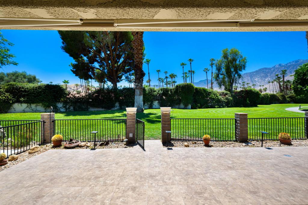 Nestled in a prime location with breathtaking mountain views, Sunrise East situated on fee land is renowned for its low-density design and exceptional amenities, including six pools & spas, two tennis courts, and four pickleball courts. Spacious renovated kitchen with abundant cabinet space, granite counters, and large windows for natural light. The spacious living room features a custom fireplace surrounded by built-in custom lit shelving. The expansive primary suite with mountain view and skylight providing natural light in the renovated ensuite bathroom. A generous second bedroom with renovated ensuite bath. The third bedroom, currently used as a den with expanded space where the atrium used to be and large skylight, can either be converted back to a bedroom or enjoy the currently expanded den and office area adding additional living space. Step onto the fenced large patio off the living room with retractable awning to enjoy magnificent Southwest views of the San Jacinto Mountains and the lushly landscaped grounds. The two-car garage, with direct access to the unit, has lots of storage space, laundry area, and skylight. Mature citrus trees and verdant greenbelts frame the property. Experience the best of Palm Springs living in a home that perfectly balances tranquility, convenience, and timeless style. Don't miss this exceptional opportunity to experience resort-style living at its finest.