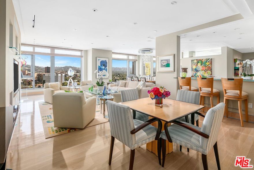 Step into this rare double-unit in one of the most prestigious full-service buildings on the Wilshire Corridor, the Californian. Pristine & sophisticated condominium consisting of apx. 5,280 sq.ft. of living space with 4 bedrooms & 4.5 bathrooms & boasting stunning panoramic views throughout. Elevator opens directly into private foyer leading into the spacious and bright public rooms with flowing, open floor plan. Living room with built-ins, formal dining room with elegant built-in bar, family room, & spacious gourmet kitchen with center island, professional appliances, balcony, & adjoining breakfast room. The luxurious master suite is much like its own private residence complete with lounge/office space, balcony, oversized custom walk-in closet with island, & gorgeous master bathroom with separate tub & shower & dual vanities. 3 addl bedroom suites, powder room & laundry room complete this fabulous unit. Five-star building amenities include concierge, valet, fitness center, pool & spa