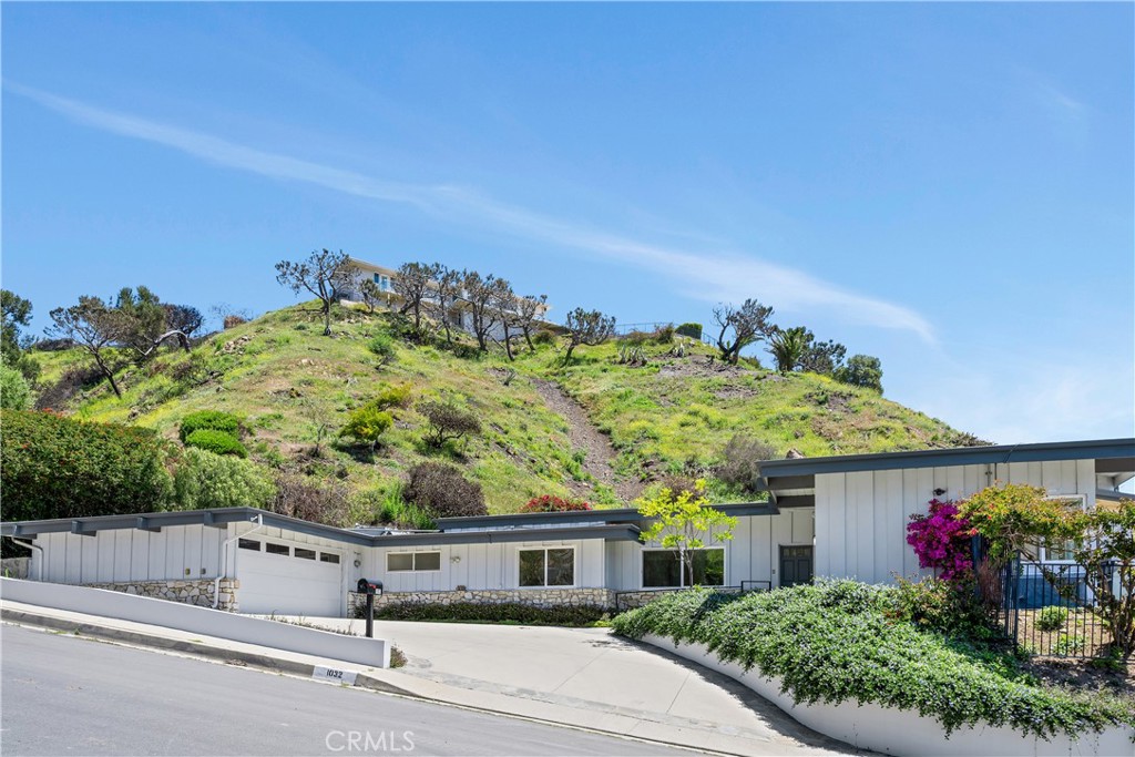 This classic four bed three bath Pacific Palisades home in the beautiful Marquez Knolls neighborhood is available for lease to qualified applicants. Updated in 2005, Enchanted Way is in excellent condition with hardwood and stone floors throughout and carpet in the primary bedrooms and the living room. The home can come fully or partially furnished, including bed frames, dining tables, chairs, and coffee tables. Nearly every room offers beautiful ocean and/or mountain views, the primary has lovely views and easy access to the pool yard and the citrus trees in the garden. The living room and the opens to enjoy easy access and great views of the pool. The kitchen is spacious, surrounding an island that offers barstools and work space, with grand views of the ocean and Santa Monica Bay. There is a two-car garage and a large driveway that can accommodate three additional vehicles. The large backyard has a swimming pool, fruit trees: and plenty of room for a BBQ and seating for entertaining while enjoying the ocean and mountain views. Surrounded by homes that have maintained the beauty, privacy and warmth of the Palisades, this offers the opportunity to be home.