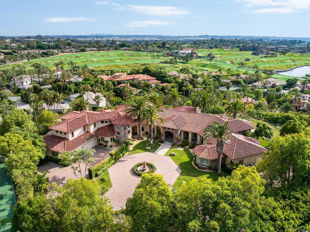Set on 2.39 acres of lush, tropical grounds, this grand Mediterranean estate offers sweeping views of the RSF Farms Golf Course and beyond. Located within the highly exclusive, guard-gated community of Spyglass, this property is a true sanctuary of privacy, luxury, and timeless elegance. A gated entrance leads to a long, winding driveway culminating in a stately motor court with tranquil fountain. Oversized beveled-glass double doors welcome you into a dramatic foyer that opens to the expansive formal living room, featuring a stately fireplace and panoramic vistas. Adjacent is the formal dining room with seamless access to the resort-style pool and spa, ideal for indoor-outdoor entertaining. The richly appointed wood-paneled office, complete with fireplace, offers an elegant space for work or study. The luxurious primary suite is a private retreat featuring a cozy sitting area with fireplace, an opulent spa-inspired bath, dual dressing rooms, and a versatile adjacent room ideal for a gym, office, or massage space. The recently remodeled chef’s kitchen is a culinary masterpiece, boasting high-end appliances, a spacious island with bar seating, and a casual dining area that flows effortlessly into the expansive family room—accented with custom woodwork, a full bar, and wine cellar. The main level also includes a guest bedroom suite, two powder rooms, a well-equipped laundry room, and direct access to the attached four-car garage. Upstairs, discover four generously sized bedroom suites, most with access to large view balconies, plus a versatile bonus room—perfect as a playroom or lounge. A detached one-bedroom, one-bath guest house offers the same architectural charm and luxurious finishes as the main residence. It features a spacious great room with fireplace, ideal for visitors or extended family stays. Outdoor living is truly elevated with a summer kitchen, outdoor bar, ample seating areas, and a stunning pool and spa surrounded by mature landscaping and manicured grounds. Spyglass Lane features interlocking pavers and an additional gate for enhanced privacy. Perfectly positioned close to major highways, upscale shopping, world-class beaches, and award-winning schools—this is Southern California luxury living at its finest.