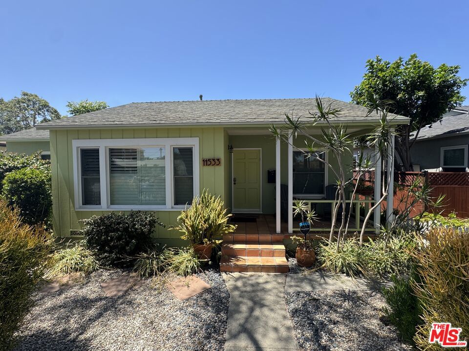 Welcome to this vibrant and beautifully upgraded Mid-Century home located in the heart of West Los Angeles. Meticulously remodeled by a conscientious homeowner, this residence seamlessly blends classic design with modern comfort, offering a warm and inviting living experience in one of LA's most desirable neighborhoods. Set behind a charming white picket fence, this home radiates curb appeal and warmth from the moment you arrive. The front yard has been landscaped with drought-tolerant plants, adding beauty and function with minimal maintenance. In the rear, tall custom fencing provides privacy and a sense of seclusion in the backyard. Inside, you'll find a light and bright interior filled with natural light, restored hardwood floors, and cheerful mid-century charm throughout. The home features all new windows and custom shutters, elevating both style and energy efficiency. The seller hired an experienced and talented design team to infuse the home with a timeless California beach vibe, blending laid-back sophistication with vibrant, sunny accents. From the color palette to the finishes, every detail was chosen to reflect the spirit of Westside living, relaxed, stylish, and welcoming. The spacious living room flows effortlessly into the dining area and fully remodeled kitchen, which is equipped with stainless steel appliances, a dishwasher, microwave, and generous cabinetry. The layout is open and ideal for both everyday living and entertaining, with thoughtful upgrades throughout. Central heating and air conditioning are controlled by a Nest thermostat, and the home includes smart features like Alexa integration, a smart lock entry system, and high-speed Wi-Fi. This single-level residence offers three bedrooms and two fully remodeled bathrooms. The primary suite includes a private en-suite bath and direct access to the backyard through a side door, while the hallway bathroom features clean, modern finishes and a tub-shower combination. A dedicated indoor laundry room includes a side-by-side washer and dryer, along with extra storage space for added convenience. Step into the beautifully landscaped backyard private retreat perfect for entertaining, relaxing, or simply enjoying the outdoors. A tiled patio area provides the ideal setting for outdoor dining, while mature landscaping, a grassy lawn, and a vintage-style outdoor soaking tub add unique character and charm. The entire property is enclosed with tall, custom fencing for a peaceful and secure environment. Room for RV parking or adding an ADU.