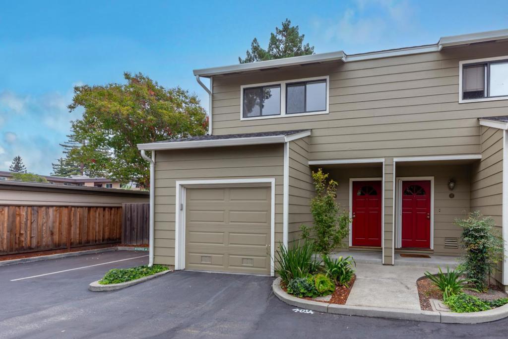 Tucked away at the back of the sought-after Village Wood community in one of its most private end-unit locations, this light-filled home boasts fresh updates, style, and indoor/outdoor flow. The main level offers sunny living and dining rooms, and a spacious kitchen with hardwood floors, deep countertops, a greenhouse window, and a convenient pass-through to the dining room. The living room has a corner fireplace and backyard views, while the dining room includes a drum light, tall window, and a glass door to the yard. Outside, enjoy a large concrete patio shaded by a towering redwood tree, stone walking paths, mature landscaping, and a garden sitting area. Upstairs, two luxe bedroom suites each feature mirrored closets and updated baths, and one has a large private balcony overlooking the backyard. Added amenities include a main-level powder room, in-unit laundry, an attached one-car garage, and adjacent guest parking. Located in a fantastic pocket of Mountain View just minutes from vibrant Castro Street and major tech employers including Google.