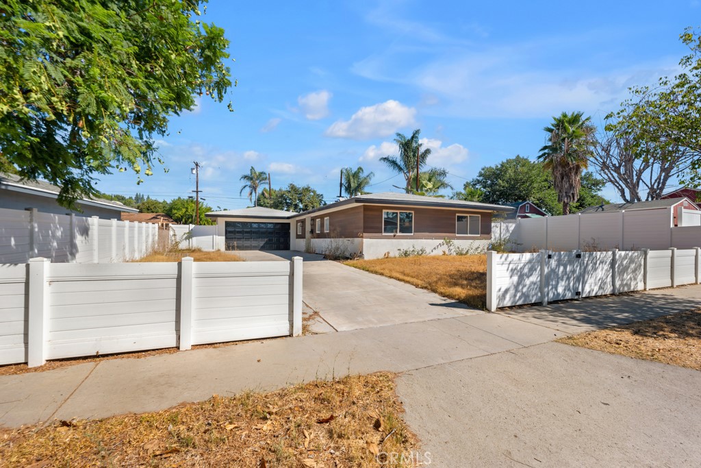 Incredible Opportunity in West Hills with Building Plans Ready! This is your chance to own a 3-bedroom, 2-bathroom single-family home with huge upside potential—offered at a fantastic price and including ready-to-build approved plans for 3 additional units! Situated on an expansive 8,402 sqft lot, this 1,144 sqft home is perfect for investors, multi-generational living, or anyone looking to live in one unit and rent out the others. Inside, you’re welcomed by a bright living room featuring laminate wood flooring, recessed lighting, a cozy fireplace, and a charming reading nook by the window. The kitchen is both stylish and functional, offering ample cabinet space, all your necessary appliance hookups, and a comfortable dining area ideal for a small family. Convenient garage access through the kitchen allows flexibility for those who may keep the garage as-is rather than converting it. Down the hallway, you’ll find generously sized bedrooms with recessed lighting and plenty of closet space. Two bedrooms share a well-appointed hallway bathroom, while the primary suite includes its own private ensuite bath—both showcasing modern finishes. Outside, a spacious covered patio opens up to a large grassy yard, ready for your imagination—whether that means enjoying it as-is or moving forward with the included building plans. The approved plans allow for incredible expansion: a 1-bedroom unit in the garage, a 3-bedroom/2-bath unit above the existing home, and a separate 3-bedroom/2-bath ADU in the backyard. This is a truly rare find in West Hills—recently renovated about 2 years ago, move-in ready with only minor TLC needed, and offering unbeatable potential with approved plans in hand. Whether you’re an investor, a homeowner looking for rental income, or a large family needing multiple homes on one lot, the possibilities here are endless.