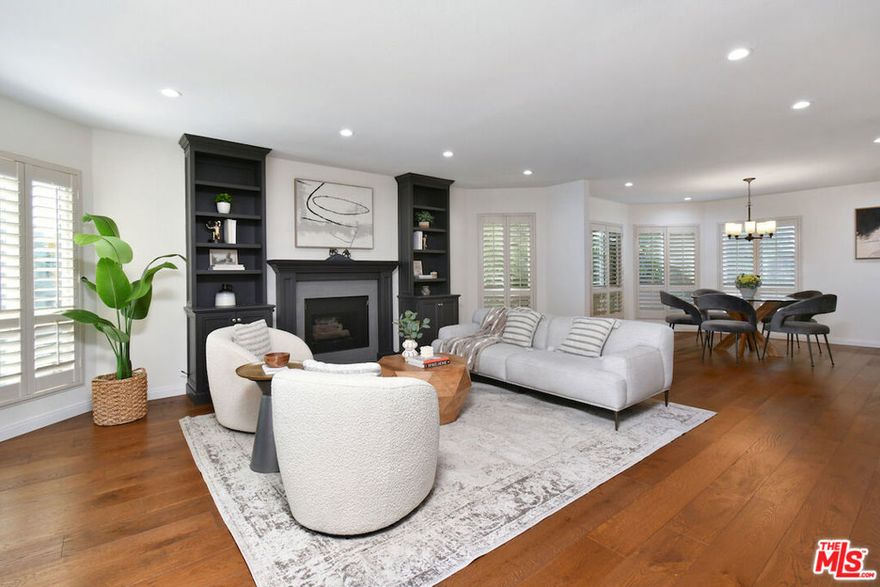 Experience exceptional living in the heart of Toluca Lake. This beautifully updated three-bedroom, three-bath condominium offers an expansive 1,904 square feet of single-level living space, an uncommon find in the area, where most condominium homes are smaller and multi-level. The open floor plan flows effortlessly between the living, dining, and kitchen areas, creating a versatile environment ideal for both relaxing and entertaining. The renovated kitchen features marble countertops, stainless-steel appliances, and modern cabinetry, complemented by recessed lighting, wood floors, and custom built-ins throughout. Dual-pane windows ensure a quiet, serene atmosphere, while an updated HVAC system and in-unit laundry provide comfort and convenience. Step onto the front-facing balcony to enjoy the breeze and tree-lined views while sipping your morning coffee, or enjoy the outdoors and explore the best of Toluca Lake Village. Discover neighborhood favorites like Prosecco Trattoria or Hungry Crowd for dinner, Gelson's or Trader Joe's for your daily shopping, and cap the evening with a show at the Garry Marshall Theatre. Additional features include a security system, two side-by-side parking spaces, ample storage, and access to a community pool and recreation room. Combining generous square footage, thoughtful updates, and an unbeatable location, this residence perfectly captures the inviting charm and vibrant lifestyle that make Toluca Lake one of Los Angeles' most desirable neighborhoods.