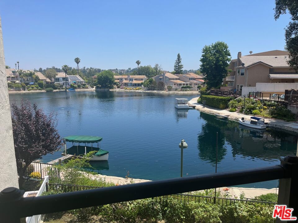 Look no further then this beautifully appointed Lake front home. This Tri - level home has lake views and yard access from nearly every room in the house. Enter in the foyer and walk up a few steps to the formal living room, formal dining room, kitchen and breakfast area with large balcony with lake view.. One level below are the extra large master bedroom with separate sitting area, master bath, large walk in closet, and and sliding glass doors that open up to the yard and lake views. Another good sized bedroom and bathroom with direct yard access and sitting area are on the bottom floor . The top floor consists of 2 more bedrooms with lake views and large balconies. There is a laundry room with hookups and a 2 car garage. Super bright and inviting. New flooring has been updated in all bedrooms.