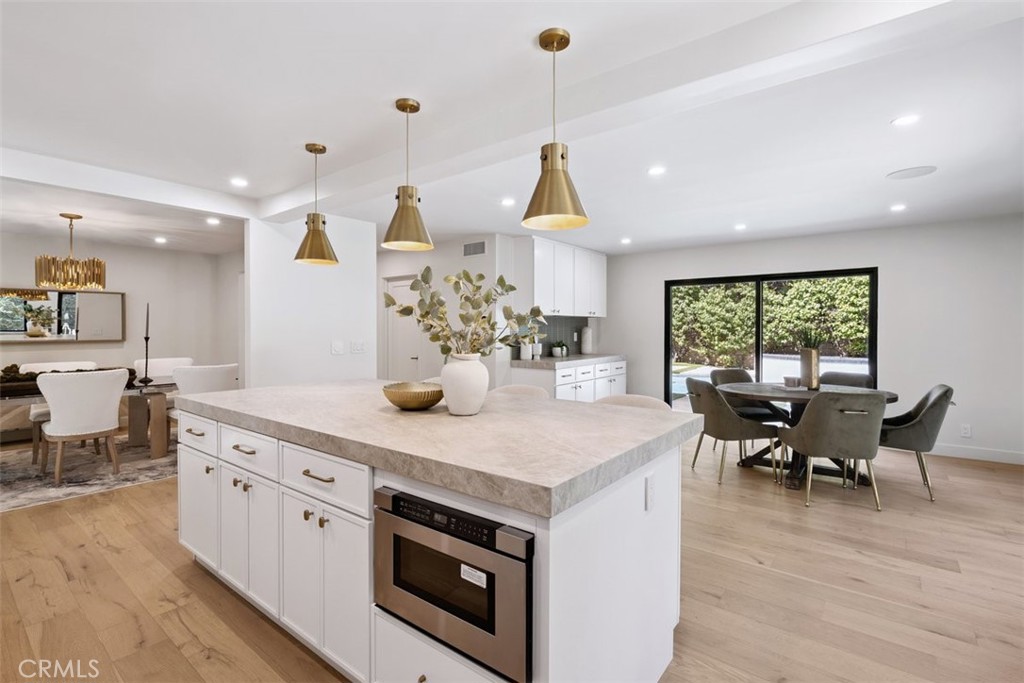 Incomparable Luxury Lifestyle & Privacy in the desirable Park Streets of Calabasas. Appreciate elevated living in this remarkable private & gated 4-bedroom, 3.5 bathroom redefined home PLUS separate ADU with it’s own full bath. Meticulously updated this open, naturally lit smart residence is a sanctuary of style, comfort, & natural beauty. From the moment you enter the double door glass entry you’ll be captivated by the formal living room with elevated ceilings, natural light from new windows & skylights, & the prominent fireplace. Perfect flow between entertaining in the lounge & enjoying the grandness of the living room. A large hallway offers easy flow from backyard to living room. Stylish dining room with modern lighting is located just off the state-of-the-art culinary kitchen with top end smart appliances & a considerable island with seating, plenty of storage, cabinets & counter space. This extra sized room also boast dining area situated between sliding doors to the pool & the brand-new top of the line BBQ. Up the glass staircase with chic chandelier, you’ll find 4 generous bedrooms. Two serviced by a beautiful, remodeled bath & another with it’s very own modernized bathroom. The primary with it’s tastefully redesigned bathroom & custom closet that offers elegance & style with the large stunning sink for two & the extra-large shower. The outdoors is a welcoming oasis featuring a glistening pool, multiple lounge & dining areas to enjoy intimate gathering or large parties. The detached pool house with full bathroom, closet, & wet bar is perfect for live in guests/ office/ studio/ gym/ possible ADU with it's own HVAC The options are endless. Home offers secure gated entry, paid off solar, new roof, & drought tolerant planting. All this and a three-car garage with new doors, epoxied floors, & storage. Too many upgrades to mention. This is more than a home—it’s a lifestyle of beauty, comfort, & privacy located in walking distance to the Calabasas Lake & its trails, summer concerts, & convenient location close to the Commons & it’s magnitude of dining & shopping opportunities. Below Market Financing Available.
