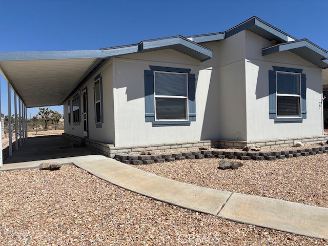 Newer mobile home in Gates of Spain, Yucca Valley's premier senior park. This immaculately maintained 2 bedroom, 2 bath home is well situated for privacy but also close enough to the sparkling pool, community recreation room and park office. The open floor plan with attractive laminate flooring invites a relaxed lifestyle and features a large kitchen with breakfast bar and dining area adjacent to the generous living room which flows into another flexible family room space. The master bedroom has been freshly painted with new carpeting installed. Walk in closet in the master bedroom is supplemented by additional storage in the master bath. Step-in shower in the master bathroom. Separate laundry room opens to the covered carport with a bonus storage shed. The covered front patio is ideal for enjoying the cool desert mornings and evenings. Exterior is freshly painted. This unit is so ready for its new owner, come have a look and become part of the friendly Gates of Spain community.