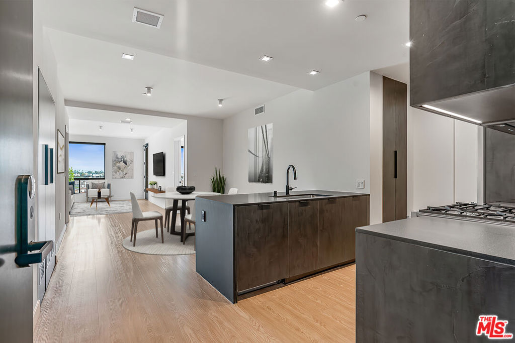 Venue Residences by Helio. This beautiful 2 bed + 2.5 bath is available on the 8th (top)floor, with South East facing views. Kitchens have unique dark finishes with stained granite counters, matte black fixtures, and stainless steel Beko appliances. The open living and dining concept allow for a good flow of the space, with a built-in dining counter for barstools, a designated area for dining, and a large living room with balcony access. The spacious bedrooms have custom built-in closets, wall mounted lighting and a remote controlled ceiling fan. Bathrooms have large mirrors, shower/tubs, and under cabinet storage. Residence also includes custom electronic window shades, smart lights, and Nest thermostats. PROPERTY AMENITIES: Large gym with Technogym equipment, 2 rooftop lounges with a heated dipping pool and outdoor cooking area, Co-working lounges, Conference room, and front desk staff. Tours are available by appointment, so please contact us today. Parking is $250/month for a tandem space, and internet $84/month.