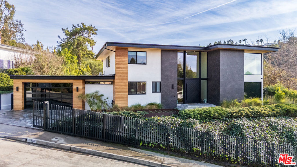 Step into a world of elevated living at this architectural gem nestled in the coveted Dona streets in the Studio City hills. With sweeping canyon views, this 6-bedroom, 7-bath contemporary estate blends bold design with serene luxury perfectly tailored for those who crave privacy, sophistication, and effortless indoor-outdoor flow. From the moment you enter, you're greeted by a dramatic glass atrium and soaring ceilings that flood the home with natural light. Every detail has been curated from the chef's kitchen with Wolf appliances, oversized Fleetwood sliders and custom walnut cabinetry to the expansive living spaces designed for both grand entertaining and intimate evenings. Upstairs, the primary suite is a sanctuary unto itself. Features include a spa like bathroom with vast two person marble shower, dual walk-in closets, and a private terrace overlooking the hills. Downstairs, a versatile layout offers guest suites, a media lounge, and seamless access to the resort-style pool, fire pit, and outdoor kitchen. Smart home features, designer finishes, and a rare combination of scale and warmth make this property a standout in today's market. Less than 5 minutes to the heart of Studio City, family life & community is exemplified with a bustling Sunday Farmers Market, numerous parks and a top tier school district. 10 minutes to WEHO & 15 to Beverly Hills. So whether you're hosting under the stars or enjoying quiet mornings with canyon breezes, 11428 Dona Lola Drive invites you to live beautifully.