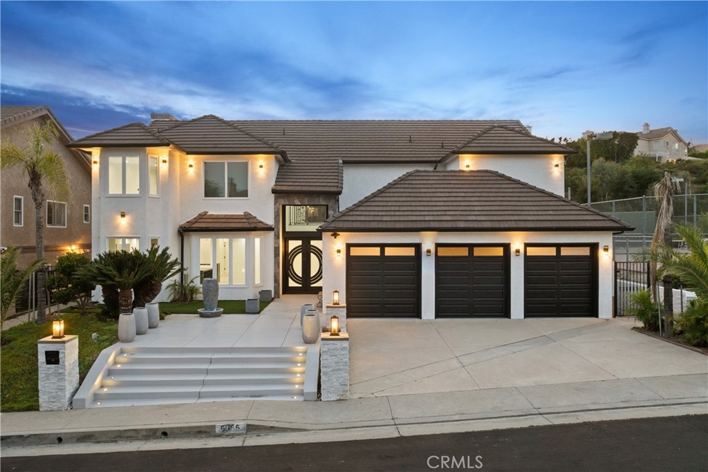 Situated on a sprawling 11,000+ sq. ft. lot in the exclusive Valley Circle Estates neighborhood of Woodland Hills, this tastefully updated home offers the very best of modern luxury living. A dramatic double-door entry welcomes you into a grand foyer with soaring double-height ceilings, setting the tone for the expansive open-concept floor plan beyond. The formal living room is highlighted by a floor-to-ceiling stone fireplace and an abundance of windows that flood the space with warm natural light. Sleek and sophisticated, the gourmet chef’s kitchen impresses with top-of-the-line appliances, quartz countertops, a waterfall island, and a spacious pantry. Just off the kitchen, the formal dining room offers an intimate setting for memorable gatherings, while the family room invites relaxed living with a cozy fireplace. Designed for entertaining, the spacious recreation room features a built-in wet bar and two sets of French doors that lead out to the resort-style backyard. Outside, you’ll find a sparkling pool and spa with a tranquil waterfall feature, a sports court, a covered patio, a built-in firepit, and mature privacy hedges that help transform the space into a true private oasis. There are four generously sized bedrooms upstairs, including an expansive primary retreat that boasts a sitting area, four large closets, and a sumptuous bathroom complete with an oversized steam shower, soaking tub, and double vanity. Additional amenities include three main-level bedrooms, a dedicated laundry room, and a three-car garage. This property is located within a top-rated school district and is conveniently close to hiking trails, Warner Center, and premier shopping, dining, and entertainment options at The Commons, Westfield Topanga Mall, and Topanga Village. To help visualize this home’s floor plan and to highlight its potential, virtual furnishings may have been added to photos found in this listing.