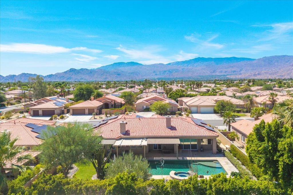 Wow, what a great location on a quiet cul-de-sac in the heart of College View Estates/Palm Desert, and no HOA, just a warm friendly neighborhood awaits you here! Newer construction and a rather well-built 4Br & 3ba 2800sq ft with all the custom features you would expect to see like the recessed lighting, crown moldings, and custom drapery. Plus the many more recent upgrades, from the grand tile entry foyer, the formal dining room with real wood flooring endless bay windows, the full chief's kitchen with walk-in panty, premium appliances and even a wine cooler. The list continues as you explore the private office/den with exquisite mahogany built-ins, or the expansive bedrooms and their baths, each with its own features like dual vanities with leather textured countertops, or custom tiled walk-in showers, and a white clawfoot tub in the primary bath! Every room exudes it's own stylish color, plus the many fine touches of luxurious wall & window treatments. This home is situated on over a quarter acre lot, so you not only walk up through a large and lovingly quaff front yard, but you also have a huge and private backyard complete with decks & covered patios, which surrounding the inviting saltwater pool & waterfall spa -simply spectacular lush landscaping & lighting. This home also boasts a separate laundry room, built-ins throughout, newer dual-zone ACs, plus a 3-car garage, solar, and much more... YOU MUST COME SEE THIS HOME TODAY!! All appliances included, and also partially furnished too -at absolutely no added cost. Pick a few exquisite pieces that you like, or ask for it all! Everything you see can be yours.