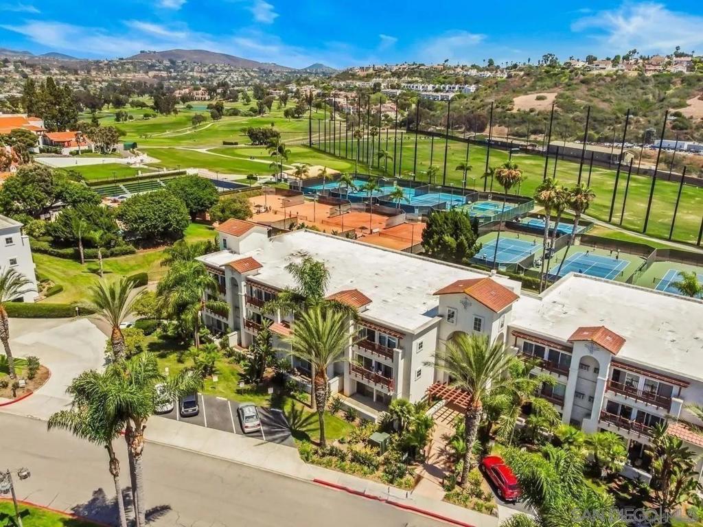 Excellent opportunity to experience resort living at this desirable top floor, end unit which overlooks lush landscaping and panoramic views of the golf and tennis grounds of the Omni La Costa Resort. The view also includes the pool and grill for the exclusive use of building's residents, surrounded by palm trees and spacious lawn. The condo is zoned for year round residential living or as an active Short-Term Rental which offers a proven profitable opportunity and investment. This unit includes unique upgraded features such as Spruce Pine wood ceilings throughout the living room and bedroom areas. Sliding glass doors open up to a generous deck that features decorative mosaic travertine stone tiles. The kitchen includes granite counter tops and a mobile custom made island which allows optional configuration within the kitchen area. Other features includes air conditioning and heat, an in-unit washer and dryer in addition to the community building's laundry room located in the garage. There is a reserved parking space as well in its underground garage. The building is equipped with security features on all building entry doors and garage gate. This condominium is within walking distance to all the features the Omni La Costa Resort which is known for its premier 18-hole golf courses and is the home of championship NCAA 2024 and 2025 golf tournaments. Also, the resort features top tennis events, musical entertainment, a world-class spa, multiple dining options, shopping and more. Come and enjoy resort living as a full-time resident, second home or as a Short Term Rental. Excellent opportunity to experience resort living at this desirable top floor, end unit which overlooks lush landscaping and panoramic views of the golf and tennis grounds of the Omni La Costa Resort. The view also includes the pool and grill for the exclusive use of building's residents, surrounded by palm trees and spacious lawn. The condo is zoned for year round residential living or as an active Short-Term Rental which offers a proven profitable opportunity and investment. This unit includes unique upgraded features such as Spruce Pine wood ceilings throughout the living room and bedroom areas. Sliding glass doors open up to a generous deck that features decorative mosaic travertine stone tiles. The kitchen includes granite counter tops and a mobile custom made island which allows optional configuration within the kitchen area. Other features includes air conditioning and heat, an in-unit washer and dryer in addition to the community building's laundry room located in the garage. There is a reserved parking space as well in its underground garage. The building is equipped with security features on all building entry doors and garage gate. This condominium is within walking distance to all the features the Omni La Costa Resort which is known for its premier 18-hole golf courses and is the home of championship NCAA 2024 and 2025 golf tournaments. Also, the resort features top tennis events, musical entertainment, a world-class spa, multiple dining options, shopping and more. Come and enjoy resort living as a full-time resident, second home or as a Short Term Rental investment property!