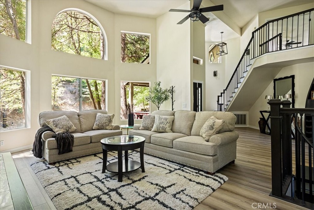 Fully Furnished Lake Arrowhead Retreat – Ideal for Traveling Professionals in Transition or waiting for a construction project to get finished. Available NOW for Monthly Stays (or longer) 4BR | 4BA | 3,196 Sq Ft | Sleeps Up to 10. Enjoy all four seasons in this beautifully remodeled and fully furnished custom mountain home. Perfect for those in need of temporary housing from one month to one year. Nestled among majestic dogwood, cedar, and oak trees, this spectacular home features 4 spacious bedrooms, 4 bathrooms, multiple living spaces including a family room, game room/office, and a bonus entertainment level with separate entry - a potential guest suite. The main level living room welcomes you with a wall of windows, flooding the space with natural light and framing forest views. Relax by the wood-burning fireplace as you watch snowfall in the winter or enjoy the golden colors of fall. The chef’s kitchen is fully equipped with an island boasting a NEW LG Signature double oven dual-fuel range, and stainless steel chef’s sink with filtered water. Each level of the home includes a cozy fireplace, new luxury vinyl plank flooring, and plush Shaw carpeting for added comfort and durability. The master suite is a true retreat, complete with a sitting area, private deck, dual-sided fireplace, oversized NEW 6-ft Jacuzzi tub, walk-in double shower, and quartz-topped vanities. A vintage clawfoot tub highlights the main-level bath, adjacent to a bedroom with walk-in closet. Step outside to a furnished patio with a propane fire pit—perfect for dining or lounging under the stars. The attached 2-car garage, level entry, and RV-friendly parking add convenience, while county-maintained/plowed roads ensure easy access year-round. Located just 5 minutes from Lake Arrowhead Village, the lake, SkyPark, grocery stores, restaurants, hospital, and pharmacy. Only 24 minutes to Snow Valley Ski Resort and a scenic commute to Loma Linda, Redlands, or San Bernardino. Additional Highlights: High-speed fast wifi included. On-site laundry. Pets allowed (with approval). Utilities included. Lots of free parking. Monthly Rent: $5,275. Minimum 1-month stay.