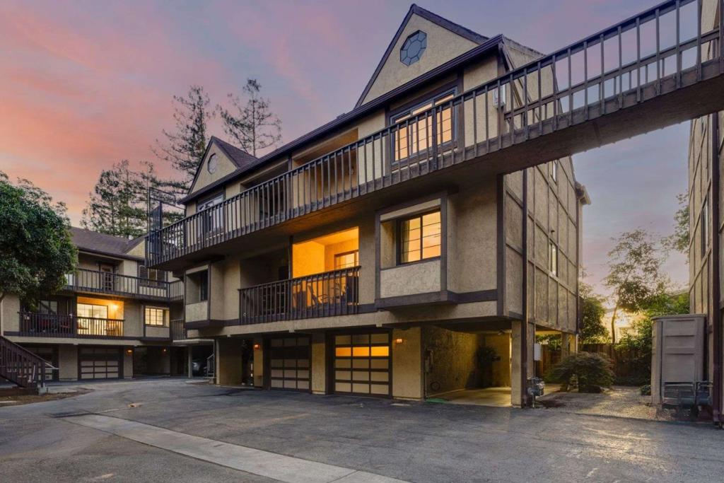 Beautifully maintained 2-bedroom, 2.5-bath townhome offering the perfect blend of comfort, style, and convenience. Set within a Tudor-inspired community featuring vaulted ceilings, an abundance of natural light, and multiple private balconies ideal for indoor-outdoor living. Step into the inviting living room complete with a statement stone fireplace, elegant laminate flooring, and a seamless flow into the dedicated dining area. The updated kitchen boasts white shaker cabinetry, stainless steel appliances, warm granite countertops, and a cozy eat-in nook that opens to a lush tree-lined balcony retreat. The spacious primary suite is a true sanctuary featuring vaulted ceilings, a large walk-in closet, and an en-suite bath with dual sinks and a modern tiled shower. A generous second bedroom includes its own private balcony, offering flexible use for guests, a home office, or additional living space. Enjoy in-unit laundry, updated bathrooms, ample storage, and two dedicated parking spaces (one garage, one carport). Located near vibrant downtown Redwood City, Caltrain, shopping, dining, and top commuter routes this is Bay Area living at its best!