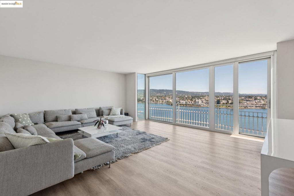 Experience one of Oakland’s premier addresses at the Lakeside Regency, a 1968 mid-century modern landmark designed by Michael Marx, AIA—an apprentice of Frank Lloyd Wright. This 19th-floor unit has stunning lake views and spans 1,300+ square feet. A wall of floor-to-ceiling windows draws you to the expansive front balcony with sweeping views of the Oakland skyline. The generous dining area flows easily from the living room, while both bedrooms, including an ensuite, offer a peaceful retreat. Both bathrooms have been tastefully updated. Enjoy the rare convenience of in-unit laundry. Additional upgrades include Hunter Douglas motorized blinds, pendant lighting, and carpet tile. Building amenities include 24-hour door service, a shared mezzanine, rooftop deck, and clubhouse. Deeded parking and private storage closet included. Pets welcome. Views: Downtown