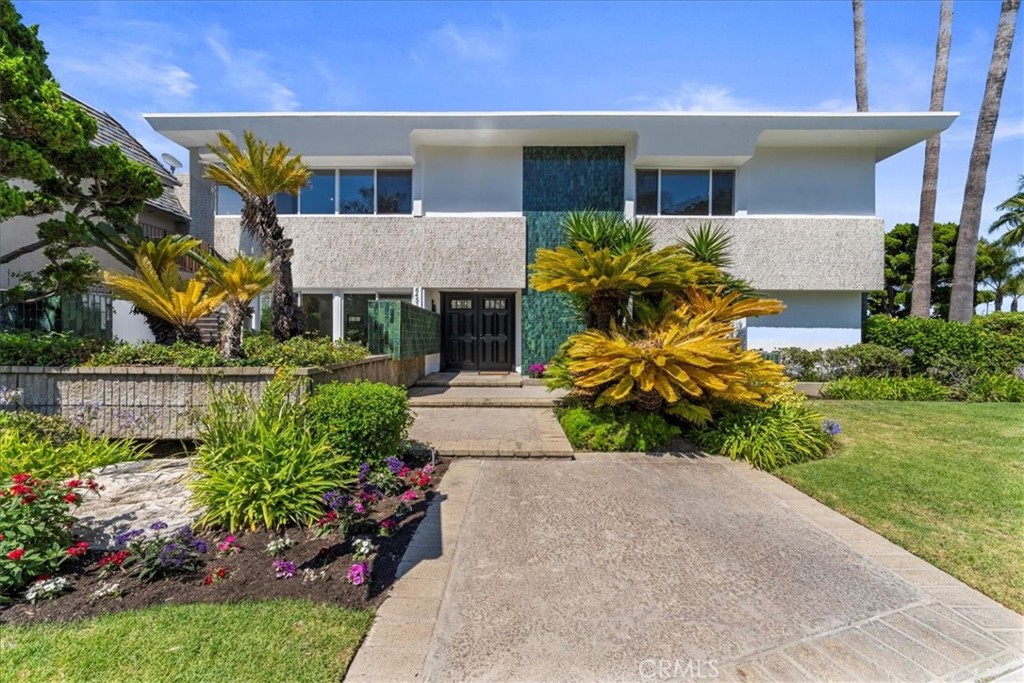 Exquisite Mid-Century Modern 5-bedroom,4-bathroom estate located in the prestigious guard-gated community of Bixby Hill. Nestled on a quiet cul-de-sac this 3,691 sq ft. residence sits on a rare 14,593 sq ft corner lot offering exceptional privacy and space. Recently enhanced with premium upgrades including a brand-new roof, high-efficiency HVAC system, new carpet, fresh interior and exterior paint, new water heater, and huge new balcony deck. A bright and airy floor plan provides multiple living areas ideal for both everyday living and entertaining. The resort style back yard is an entertainers dream, featuring a sparkling brand new pool with all new state of the art equipment and separate side yard. The attached garage includes potential for a beautifully designed ADU above ideal for extended family, guest suite, or income opportunity. Located just steps from Cal State Long Beach and minutes from coastal beaches, fine dining, shopping and major freeways. This move in ready home blends timeless style with modern convenience in one of Long Beach's most exclusive and desirable neighborhoods.