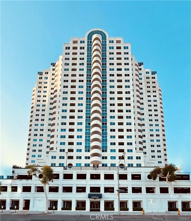 Discover the exceptional lifestyle you've always dreamed of in this premier two-bedroom, two-bath condominium at the luxurious Harbor Place Tower. Located in the vibrant heart of Downtown Long Beach, this residence offers a sophisticated living experience with breathtaking ocean and city views, Step into a bright, open-concept floor plan designed for modern living. Both bedrooms are adorned with large glass windows, perfectly framing panoramic views of the Pacific Ocean and the iconic Queen Mary, complete with a private balcony for enjoying the coastal breeze. The modern kitchen boasts granite countertops, stainless-steel appliances, ample cabinet space, and a convenient breakfast bar. The spacious primary suite features two sets of mirrored closets and an en-suite bathroom with an oversized tub, separate walk-in shower, and dual vanities. For added convenience, it comes with a washer/dryer tucked inside the closet and two assigned deeded tandem parking spaces. Harbor Place Tower offers a comprehensive suite of resort-style amenities, transforming your daily life into a vacation. Enjoy a refreshing swim in the pool and spa, relax by the outdoor lounge with a cozy fireplace, or host gatherings at the built-in BBQ facilities. Stay active in the fully equipped fitness center and unwind in the sauna room, hold meetings at the conference room. Plus, with 24/7 concierge and on-site security, your peace of mind is assured. A standout feature is the ocean-facing balcony, an ideal spot for entertaining and observing major events like the Grand Prix. This property's strategic location puts you at the center of it all. Enjoy the convenience of close proximity with easy access to the Convention Center, The Pike, the beach, the marina, and major transportation routes. With the forthcoming 2028 Olympic Games, this residence presents a unique opportunity to be perfectly positioned in a world-class event hub.