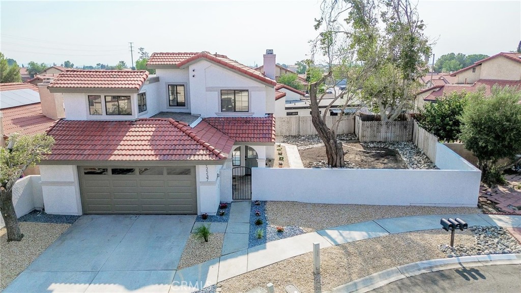 Welcome to this fully remodeled 3-bedroom, 2.5-bath home located in a desirable HOA community offering tennis courts, a picnic area, and open green space. This turnkey property has been thoughtfully upgraded inside and out, featuring fresh interior and exterior paint, smooth ceilings, recessed lighting, new baseboards, updated outlets, switches, doorknobs, and hinges throughout. The open-concept layout showcases new laminate flooring in the common areas, tile in the bathrooms, and plush carpet in the bedrooms. The kitchen has been completely redone with brand-new cabinetry, countertops, backsplash, recessed lighting, faucet, garbage disposal, and stainless steel appliances. Bathrooms have been upgraded with new vanities, countertops, faucets, mirrors, lighting, toilets, and reglazed shower enclosures, with the primary bath also offering a new shower door. Additional updates include a new iron stair handrail, fire-rated garage access door, fully painted garage with new garage door, and serviced HVAC system. The exterior has been refreshed with front yard desert landscaping, while the backyard has been cleared of vines and small trees to create a clean, open space. This home blends modern upgrades with low-maintenance living and community amenities—ready for its new owner to move right in.