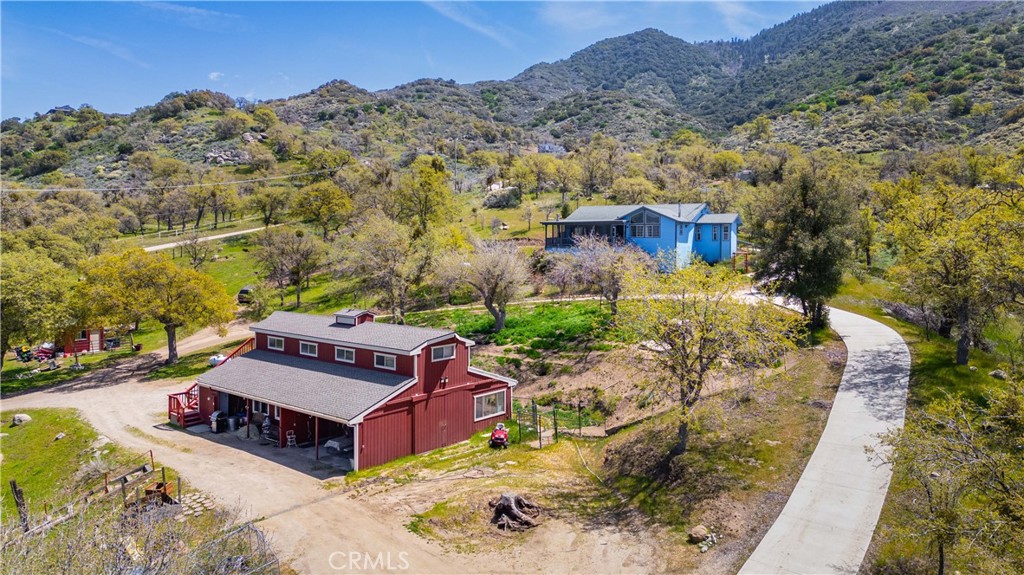 A rare and beautiful retreat where photos don’t do it justice.
This custom-built 3-bed, 1¾-bath home (1,715 sq ft) sits on 20+ acres of natural beauty with sweeping views of the valley and surrounding mountains. Crafted by local artisans, this remodeled home features custom cabinetry, a handcrafted pantry, vaulted ceilings, and large windows that bring in natural light and stunning views. The spacious living room offers built-ins, a wood stove, and central air—perfect for year-round comfort.
All bedrooms are on the main level, each with serene views. The primary suite includes a remodeled shower, and a semi-finished basement offers extra storage. A large, covered and screened porch with a wood-burning stove expands the living space, making it ideal for entertaining or peaceful solitude.
The property includes an unmetered private well with water softener, filters, reverse osmosis, and a large tank. Recent upgrades: newer roof, newer oven, dishwasher, washer, and dryer.
Outside, enjoy thousands of oak trees, a seasonal creek, and a small live stream. An organic orchard—apples, pears, plums, peaches, apricots, pistachios, pomegranates, grapes—thrives with an automatic drip system, attracting birds, bees, and blooms in every season. Over 30 species of birds have been spotted here, making it a birdwatcher’s paradise.
Also included is a fully updated two-story, approximately 1,700 sq ft second home—originally permitted as residential—with new siding, paint, roof, and cedar stairs. The top floor has an open layout divided by partial walls and beams. There’s a bedroom and full bath downstairs and a half bath upstairs, ideal for a guest suite, studio, or office.
High-speed Race Fiber Optic internet ensures modern comfort in this peaceful setting.