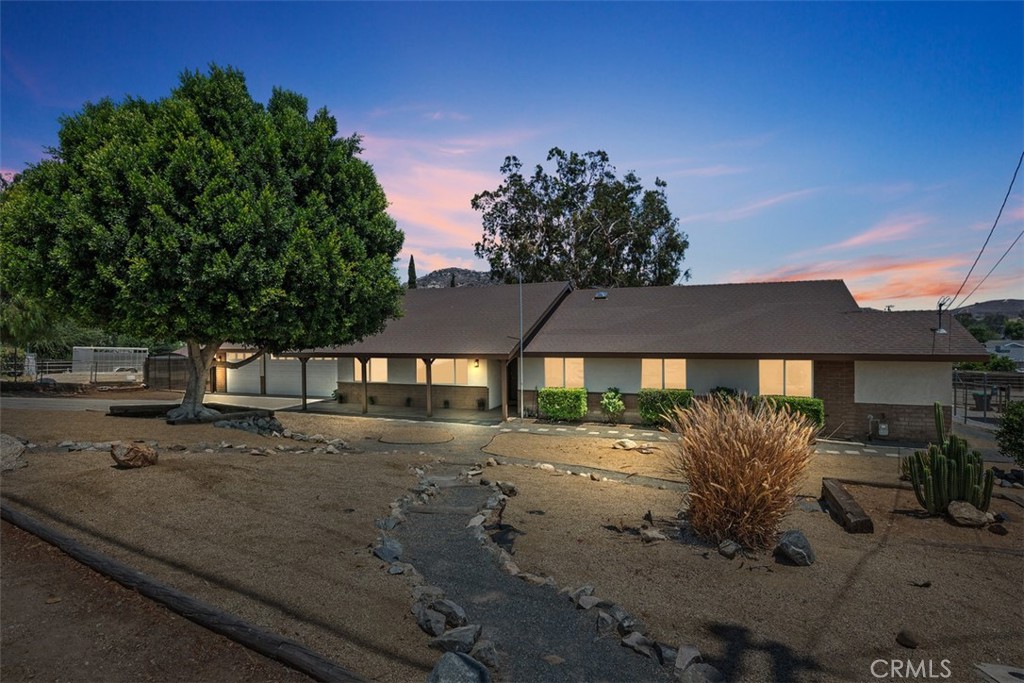 Welcome to 2703 Reservoir Drive, nestled in the heart of Norco – proudly known as Horsetown USA!
This charming ranch-style home features 4 bedrooms and 3 bathrooms on a spacious, nearly half-acre lot with amazing mountain views and quick access to horse trails—this home truly delivers!
As you enter, you're welcomed by a warm and inviting main living area with vaulted, wood-beamed ceilings and a striking rustic fireplace that serves as the room's focal point. Tile flooring flows throughout the home, offering durability and easy maintenance.
The layout includes two primary suites, each with its own private en suite bathroom, providing flexibility for multi-generational living or guest accommodations. Two additional bedrooms share a well-appointed hall bathroom with convenient outdoor access – ideal for rinsing off after horseback riding or working outside.
Step outside to enjoy all the possibilities this property offers. Whether you're dreaming of a mini-farm, a workshop, or an equestrian setup, this lot delivers. There’s ample space for RV or horse trailer parking, and access to the back of the property makes it easy to add a two-stall barn, arena, or additional outbuildings.
You'll also find two sheds perfect for tack or storage, and plenty of room for your goats, chickens, or horses. The backyard features a variety of fruit trees, including fig, apple, apricot, peach and orange—ready for you to enjoy!
The oversized three-car garage is a hobbyist’s dream with brand new epoxy flooring and plenty of space for tools or a workbench.
This tiered lot is full of potential and must be seen in person to fully appreciate all it offers. Don’t miss your chance to own a slice of Norco life! Norco, California, is a city celebrated for its strong equestrian culture and rural lifestyle, where residents enjoy direct access to one of the largest networks of horse trails in the nation. With over 400 acres of preserved parkland this area is a haven for horse lovers and outdoor enthusiasts alike.