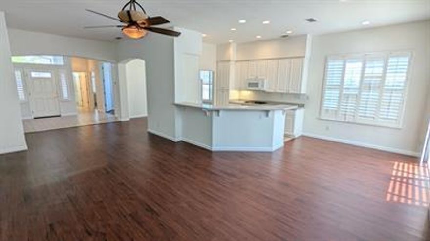 Experience resort-style living in The Villages Golf & Country Club, a vibrant 55+ community. Featuring 3 bedrooms and 2 bathrooms with AC, this unit offers a formal entry that leads to a large great room and a bright breakfast nook adjacent to the kitchen. High ceilings throughout the home create an open and airy atmosphere.   Relax in the spacious primary bedroom, which opens onto the back patio and includes a walk-in closet with built-in organizers and additional storage. The primary bathroom shines with dual sinks, an oversized tub, and a separate standing shower.  As a resident, you'll have access to over 100 social organizations and activities, including golf, tennis, pickleball, pools, and bocce ball courts. Please note that at least one resident must be 55 years or older.