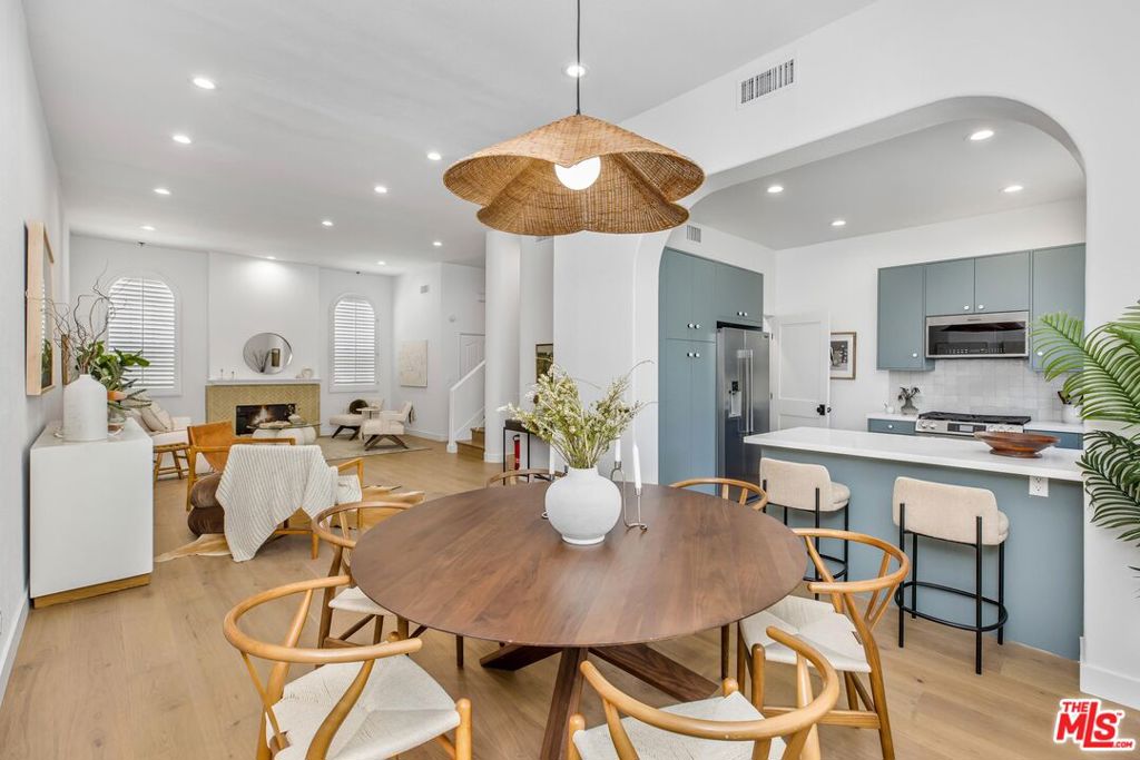 Introducing a beautifully updated townhome, ideally located south of Ventura Boulevard in Sherman Oaks! Thoughtfully designed with warmth and sophistication, this multi-level residence offers three bedrooms, a dedicated office space with closet, a private rooftop deck, and a direct-access two-car private garage. Step inside to soaring ceilings, engineered wood flooring, and a welcoming living room anchored by an elegant fireplace. The open-concept layout seamlessly connects the living and dining areas, where a charming arched window fills the space with natural light. The chef's kitchen showcases hand-selected finishes, including sleek quartz countertops, brand new appliances, and a bright, modern tile backsplash. A stylish powder bathroom, conveniently just off the entry, completes the main floor. Upstairs, all three bedrooms are thoughtfully placed on the same level, including the inviting primary suite featuring an expansive walk-in closet and a spa-like ensuite bath with dual vanities, a soaking tub, and a spacious shower. A vibrant, secondary full bath serves the two additional bedrooms. Ascend to the top floor to discover a private rooftop deck, offering sweeping, tree-lined views of Sherman Oaks, perfect for relaxed evenings or outdoor entertaining. On the lower level, enjoy a versatile bonus room ideal for a home office, guest bedroom, or gym, along with a dedicated laundry area, ample storage, and direct access to the attached two-car garage. This townhome is conveniently located within walking distance of the best shops and restaurants that Ventura Boulevard has to offer and a quick drive over the hill providing easy access to the Westside. Welcome home!
