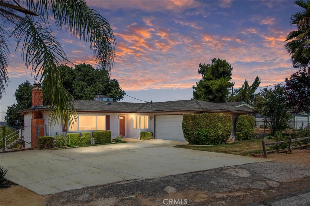 Welcome to your next home in Yucaipa! This charming residence offers a spacious, light-filled family room with a classic brick fireplace—perfect for cozy evenings. The long galley-style kitchen features white cabinetry, tile countertops, and a view into a versatile second living area or dining space, both enhanced by ceiling fans for year-round comfort.
Conveniently located off the kitchen, the laundry room provides extra storage to keep your home organized. All three bedrooms are comfortably sized and equipped with ceiling fans. The home features newer carpet and vinyl flooring throughout, adding a fresh touch.
Step outside to a generously sized deck overlooking the backyard, ideal for relaxing or entertaining. A two-car garage offers ample storage options, making this home as functional as it is inviting.