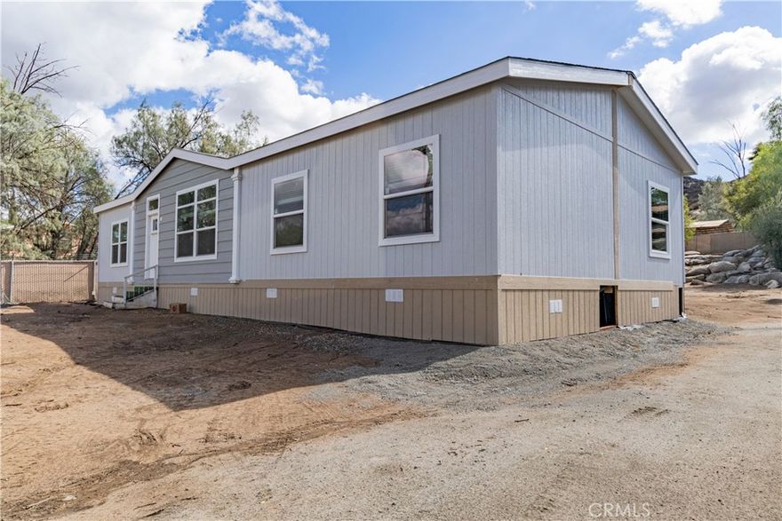 *HOME UNDER CONSTRUCTION. This house is a BRAND NEW Mfg. HOME and is situated in the heart of Homeland. The home is 1,600 sqft (approx), has 4 bedrooms, 2 bathrooms, and sits on a 0.5 acre lot. The home was built with an open floor plan and includes stainless steel appliances, carpeting, wood floors, fire sprinklers, and ceiling fans. The 0.5 acre lot allows for plenty of room to store and park RV's, boats, motorcycles, and other equipment, while the large electric wrought iron gate at the front driveway offers security and piece of mind. The property is fully fenced, with extensive cement work, including a cement driveway and patio. Wrap-around stairs lead up to the front door, making for an elegant entrance. A carport for parking is also on the property. This home's proximity to the Hwy 74 allows for easy access to the 215 freeway and Hemet to commute. Close to schools, shopping, and dining. A must see, schedule your showing today!