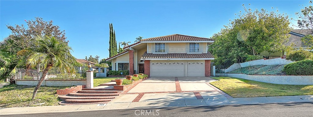 Come see this beautiful corner lot property with an ADU in the seldom available Chaparral Heights subdivision of Walnut. A community with spacious, almost half acre lots, offers privacy and seclusion. Walk to Suzanne middle school or Walnut High school. Walnut Valley school district is one of the top school districts in the state. The main home has 5 bedrooms and 3 baths, with one bedroom and bath downstairs and 3120 sf. The permitted, separate, 825 sf. one-story guest house offers 1 bedroom and 1 bathroom with a large living room, a kitchen, dining area, and a pool spa view. The property offers exemplary multi family living with 2 homes on one lot. There is super curb appeal and plenty of curbside parking when entertaining. The herringbone brick porch leads to a double door entry. The foyer opens to a cathedral ceiling, tiled floor, and a view of the living room and spiral staircase. A formal dining room blends to the living room. The kitchen is open to the family room. It was formerly remolded with Alder cabinets, stainless steel appliances, and granite countertops. A 5-burner gas cooktop and vented high efficiency exhaust hood makes cooking a pleasure. The refrigerator is included along with a built-in beverage cooler on the center island. The family room has sliding door access to the back yard w/wood shutters. A brick faced fireplace warms the room. A wet bar is available for entertaining. Upstairs are 4 additional bedrooms. The primary bedroom is at the back of the home with views to the back yard, ADU, & pool/spa. Enjoy your private balcony, accessed via a sliding door and wood shutters. Vaulted ceilings provide abundant light and an open atmosphere. A luxury bathroom with twin sinks, separate tub/shower, a walk-in closet, and a private water closet. The back yard is ideal for entertaining with a pool/spa, covered patio, firepit, and a lush lawn. Enjoy your own apple and citrus trees too. Flooring was left alone so the buyer can choose their style. Fresh paint throughout the interior. The home was previously re piped with PEX. Reroofed in 2004. Award winning schools are a short 5-to-10-minute walk away. Walnut offers comfortable living in a gorgeous setting.